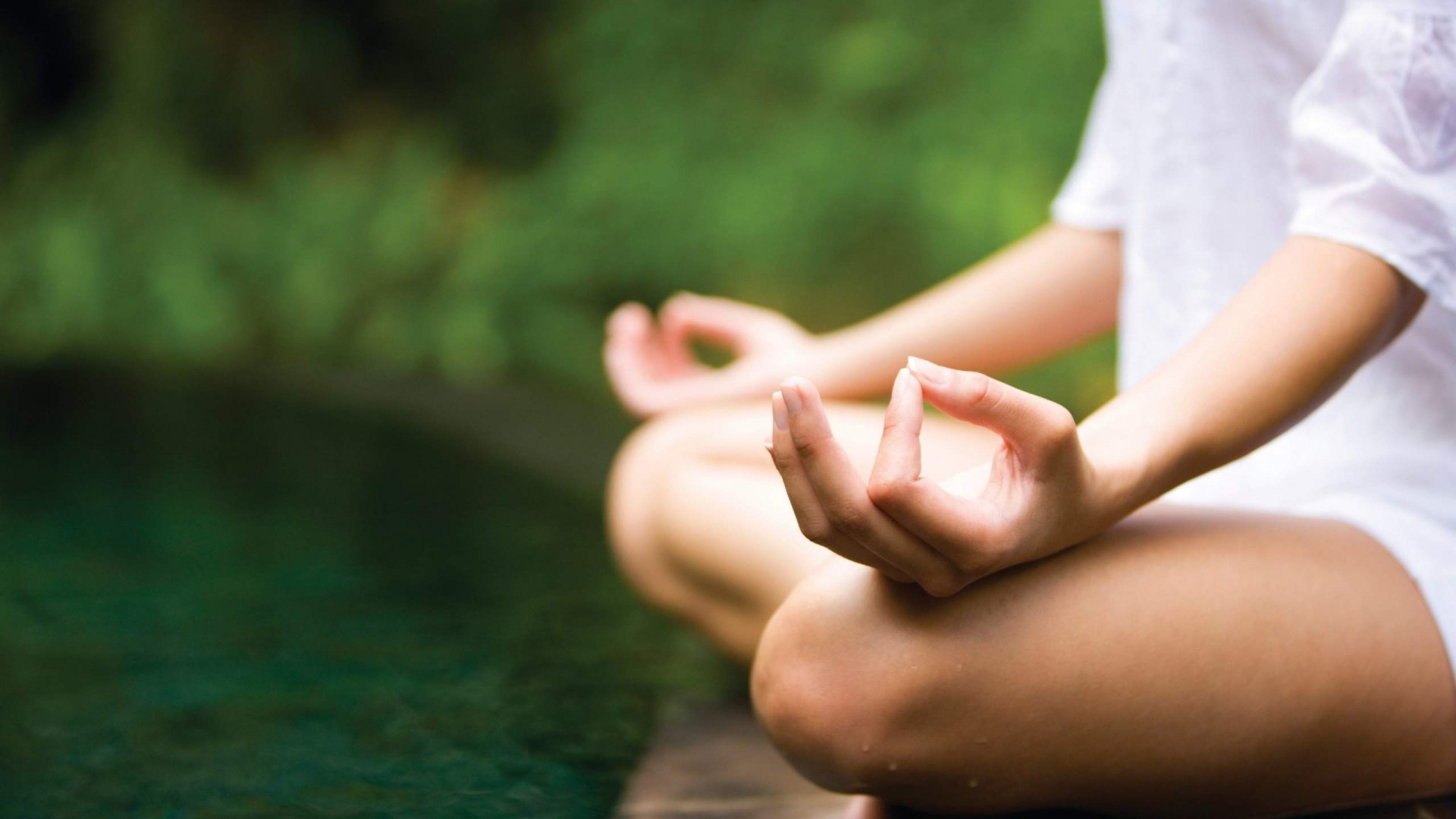 Person meditating in a lotus pose HD Wallpaper