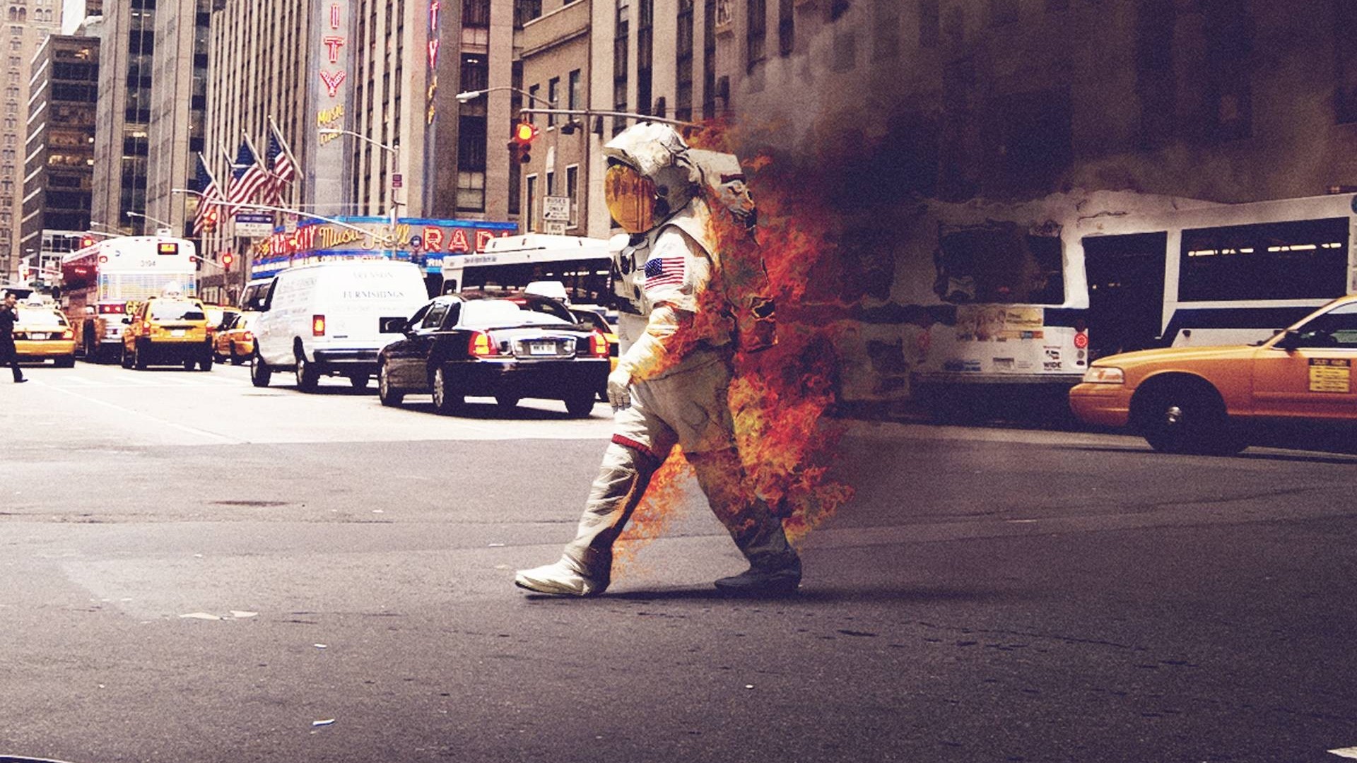 Astronaut on fire crossing a city street HD Wallpaper