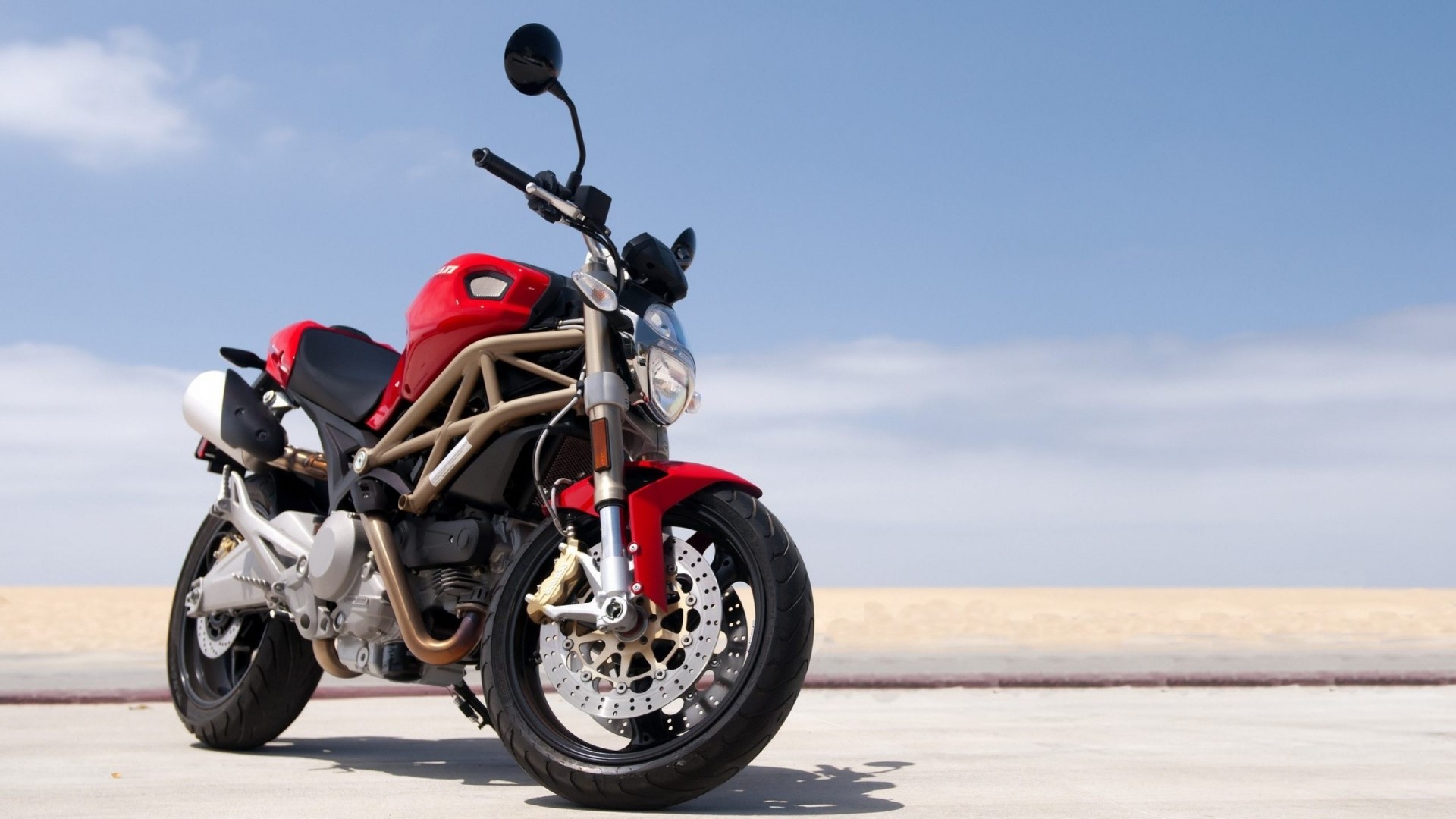 Red Ducati Monster Motorcycle on a Beach HD Wallpaper