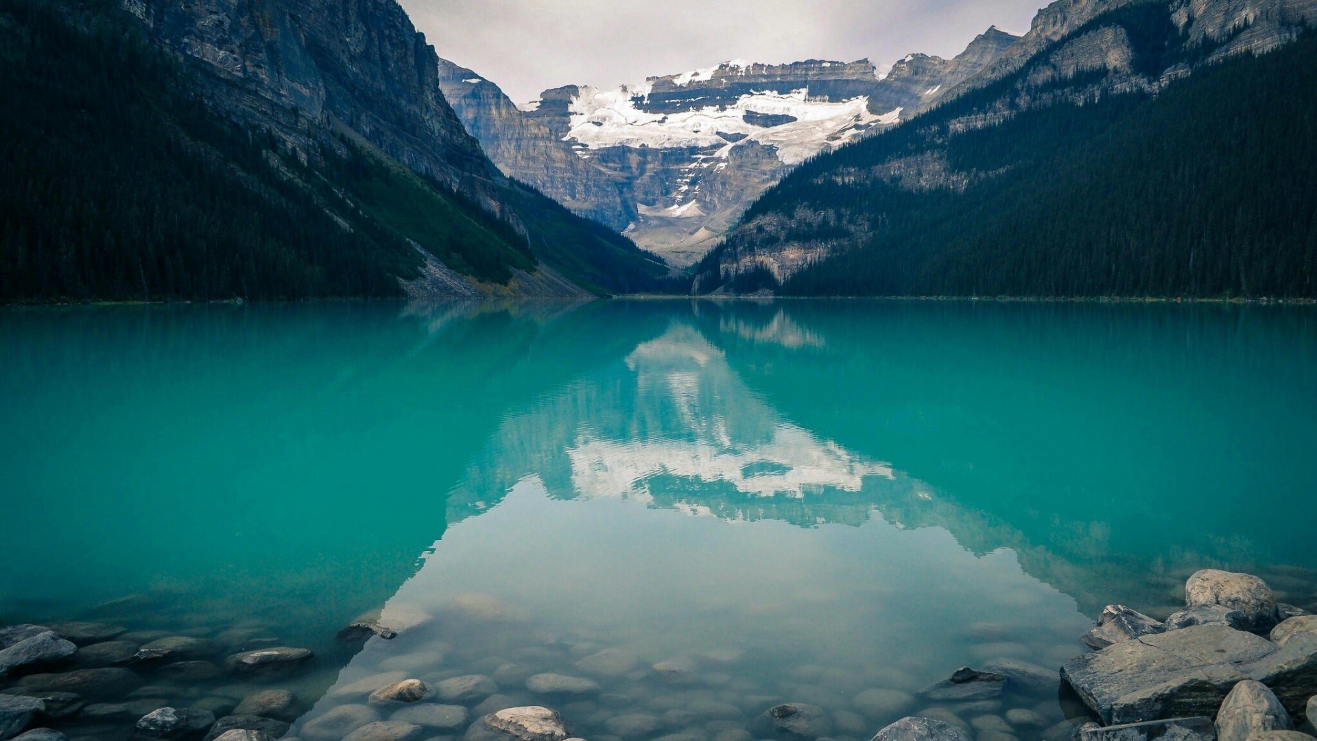 Turquoise Lake Reflecting Snow-Capped Mountains and Forest HD Wallpaper