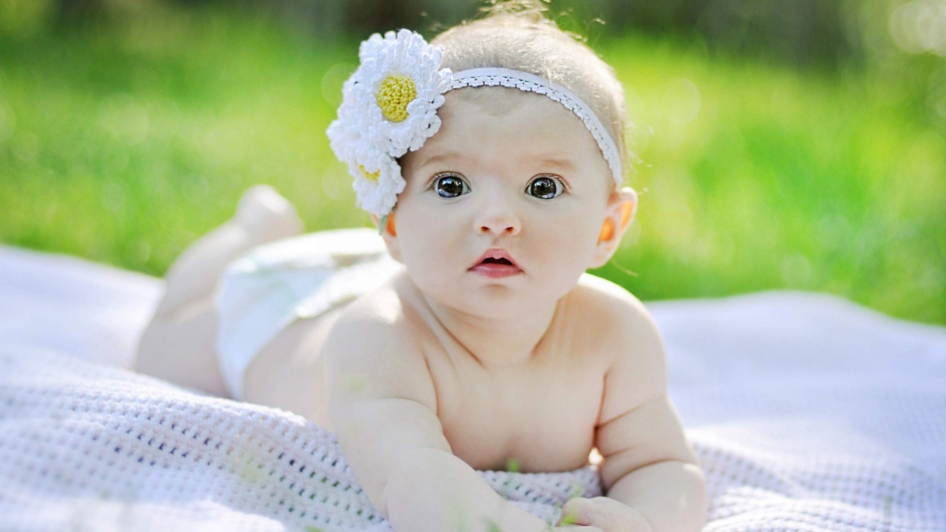 Baby girl with flower headband outdoors HD Wallpaper