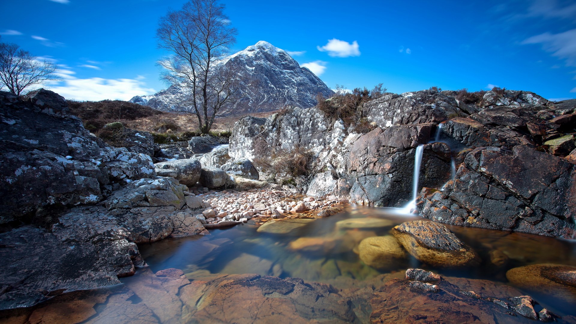 Mountain landscape with a waterfall and stream HD Wallpaper