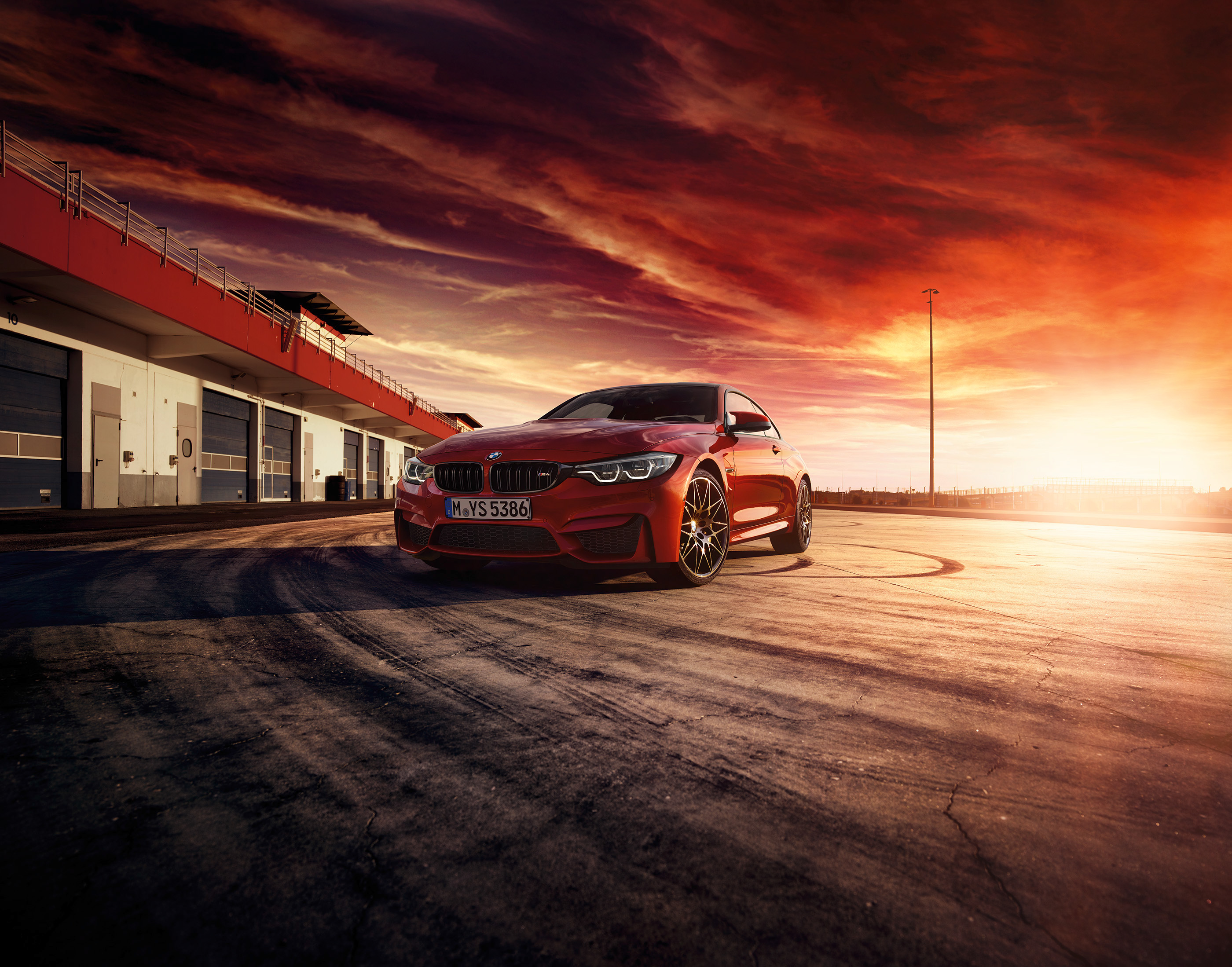 Red 2018 BMW M4 on Race Track at Sunset HD Wallpaper