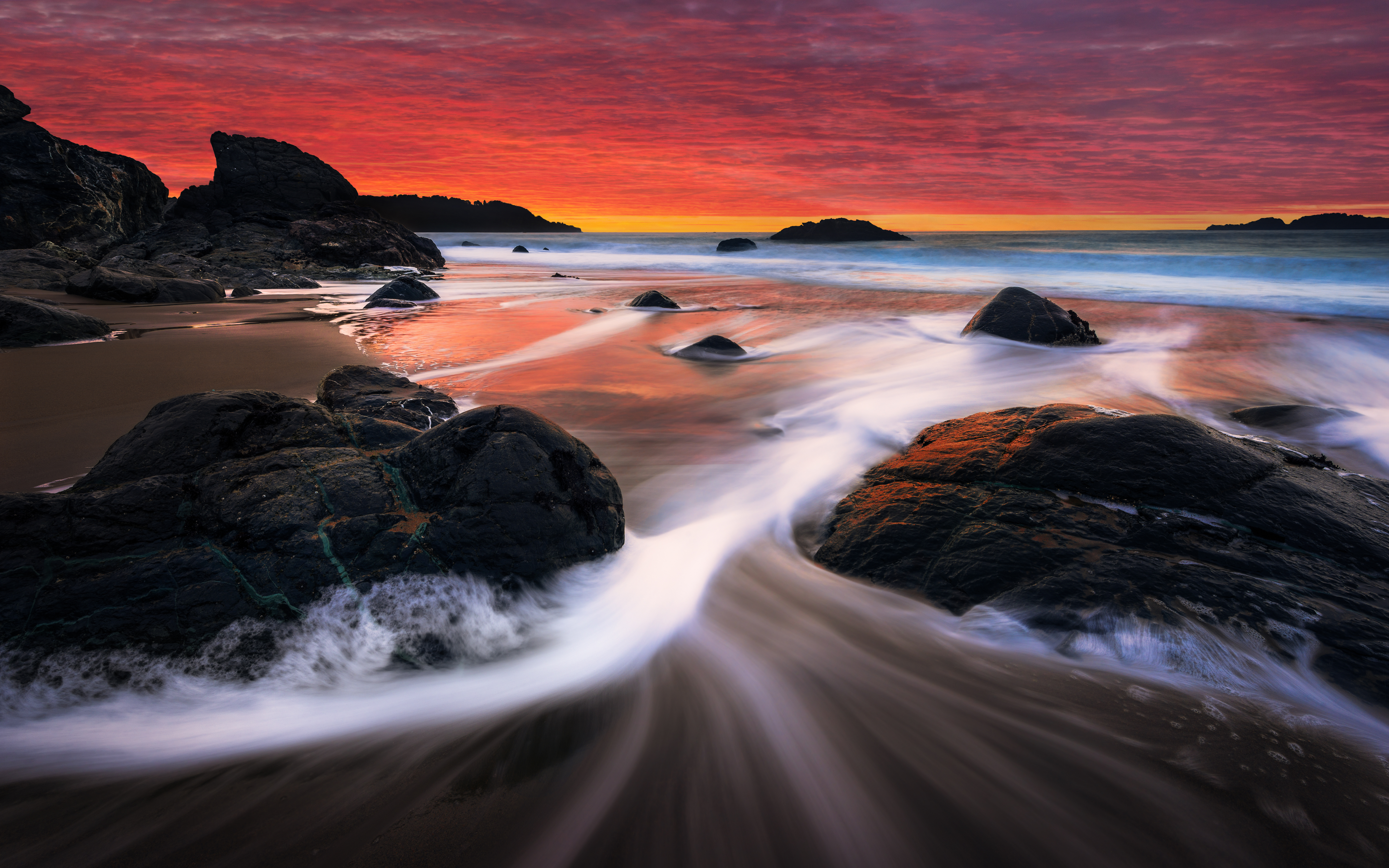 Sunset over Marshall Beach with rock formations HD Wallpaper