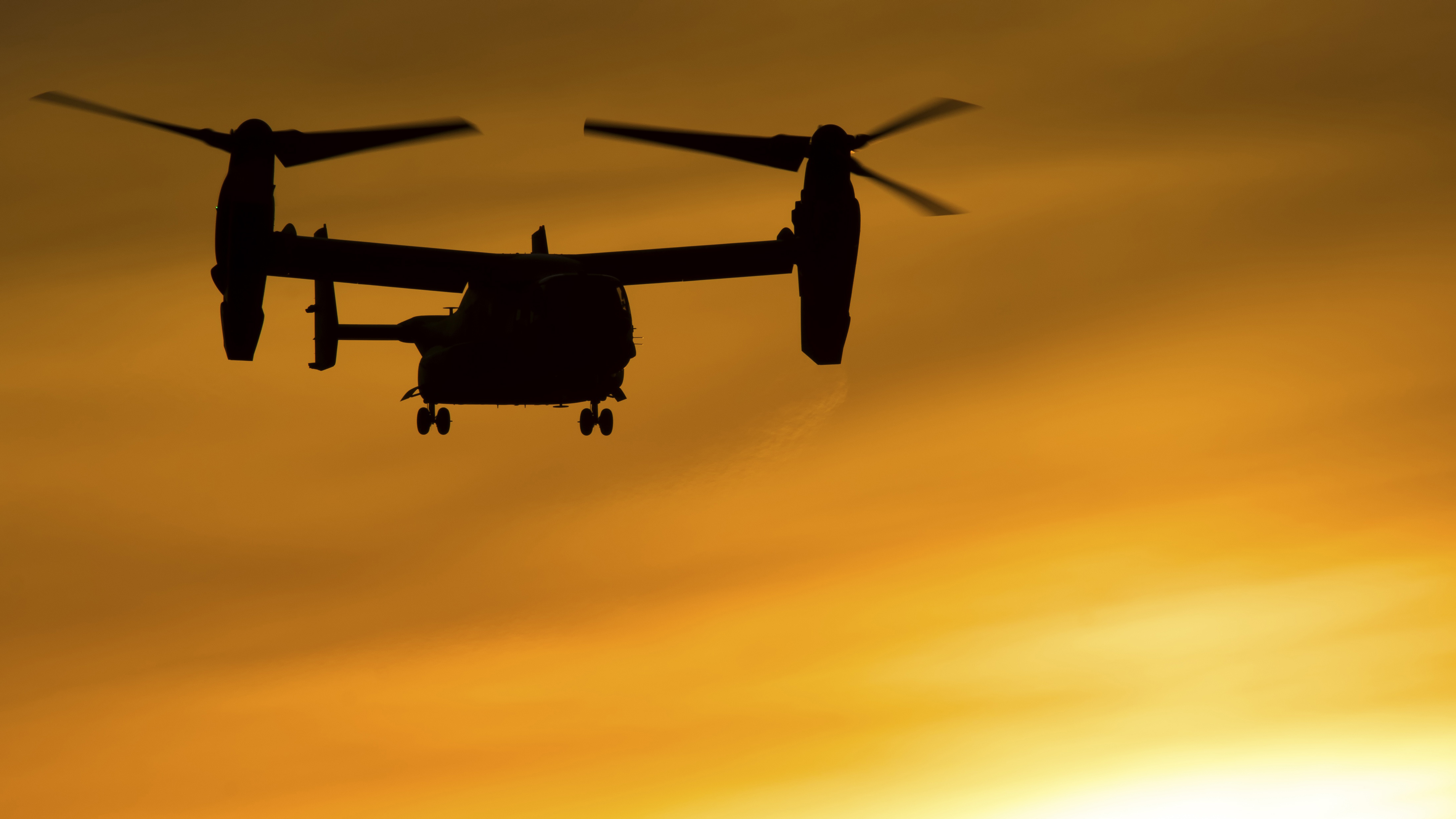 Bell Boeing V-22 Osprey in silhouette against sunset HD Wallpaper
