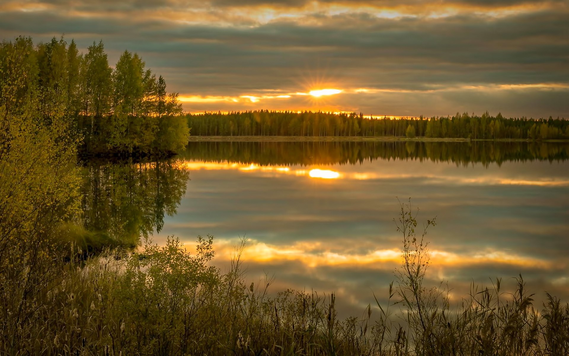 Sunset over a calm lake with trees and reflections HD Wallpaper