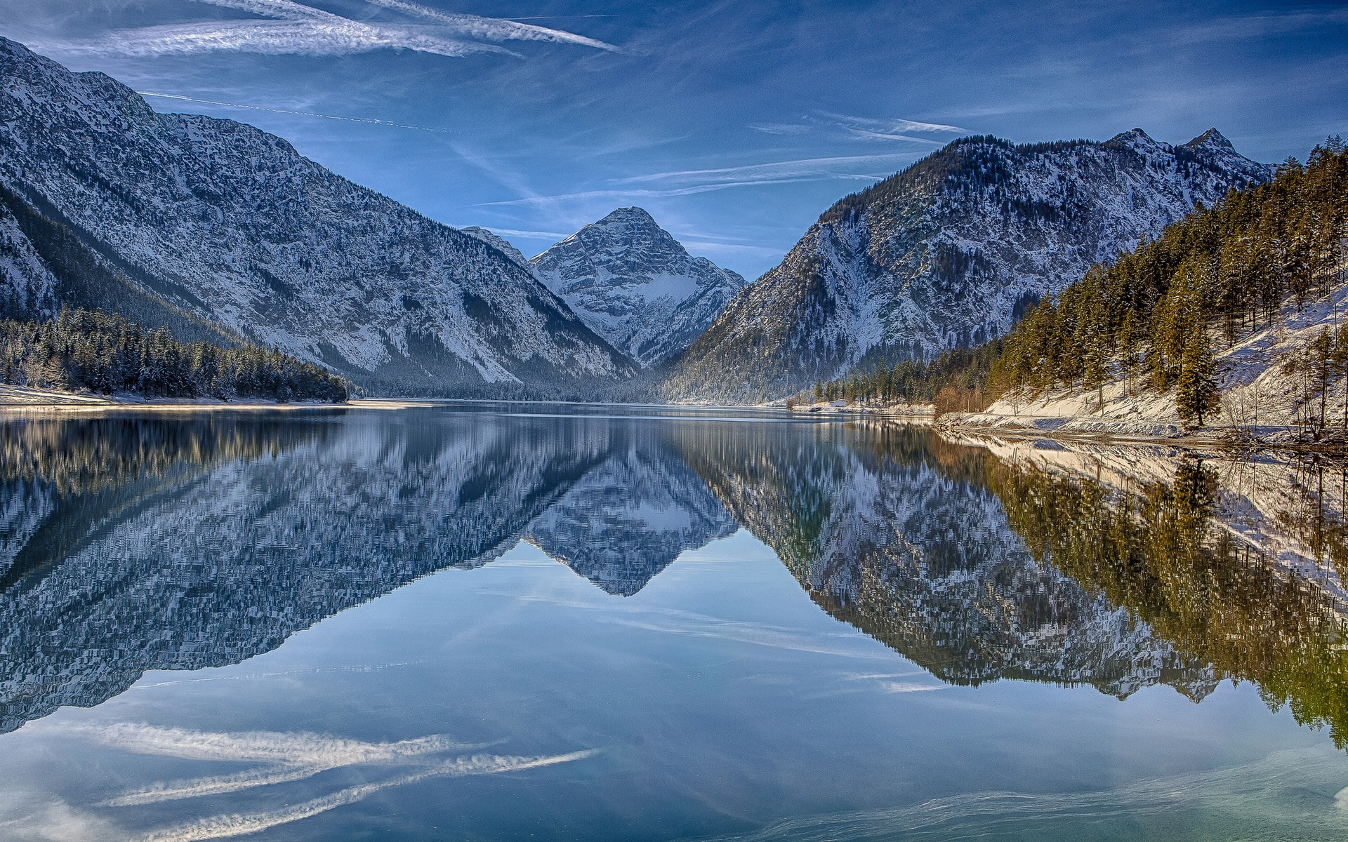 Snow-capped mountains reflected in a calm lake HD Wallpaper
