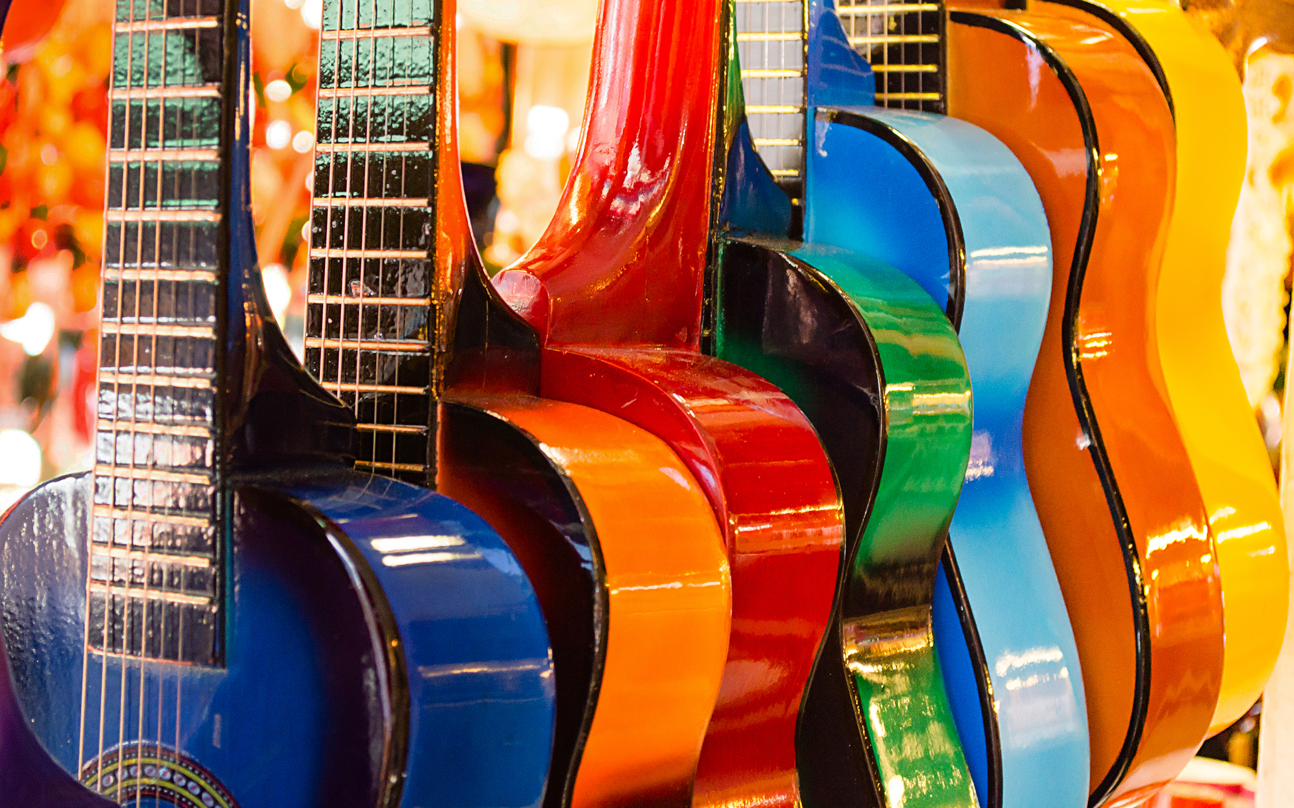 Row of colorful acoustic guitars HD Wallpaper