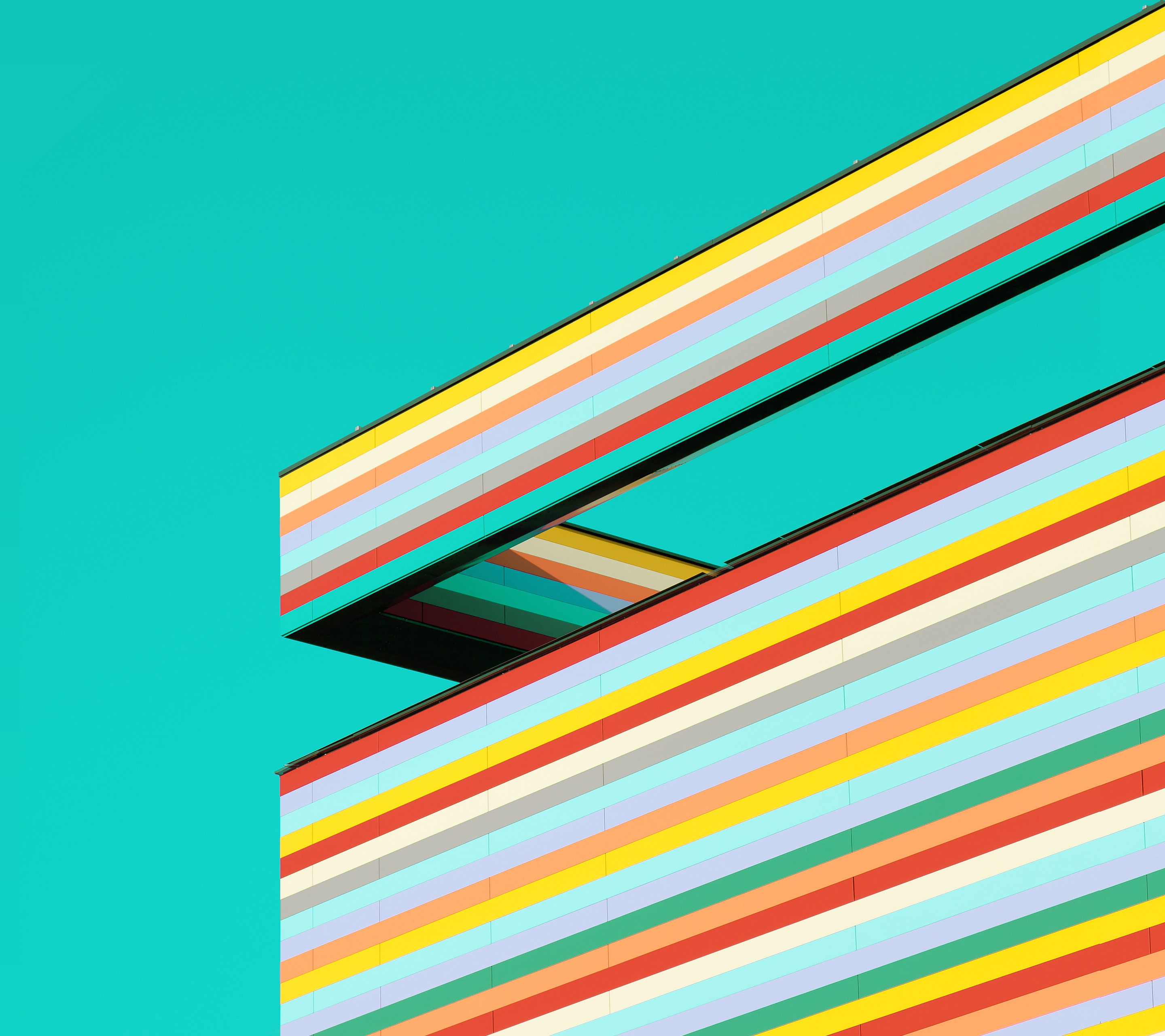 Colorful striped building against a teal sky HD Wallpaper