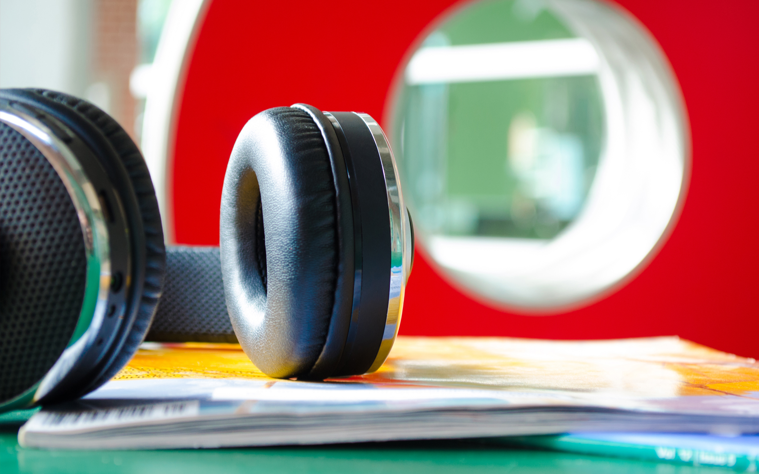 Headphones on a stack of magazines HD Wallpaper