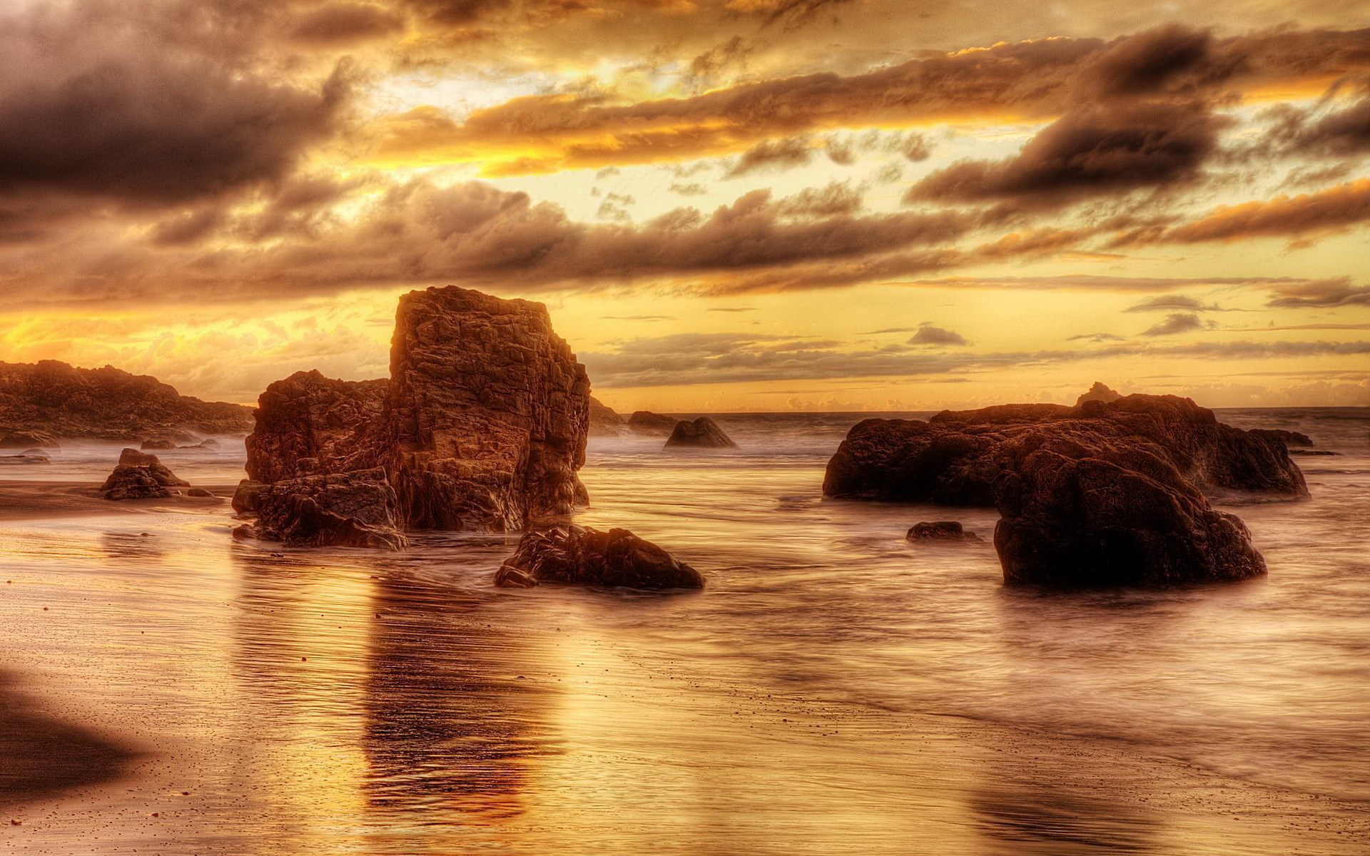 Rocky beach at sunset with dramatic clouds HD Wallpaper