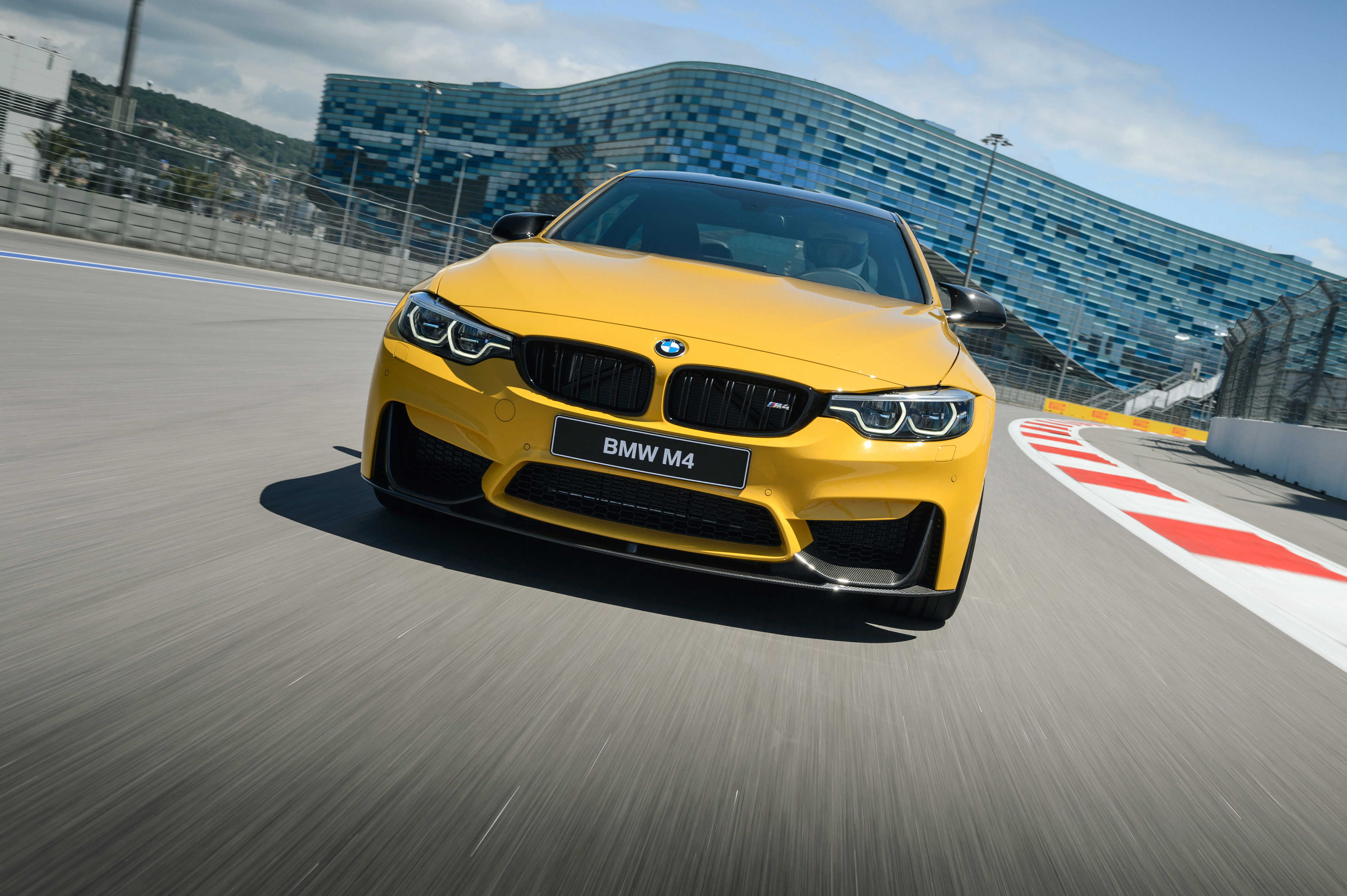 Yellow BMW M4 Competition on a Race Track HD Wallpaper