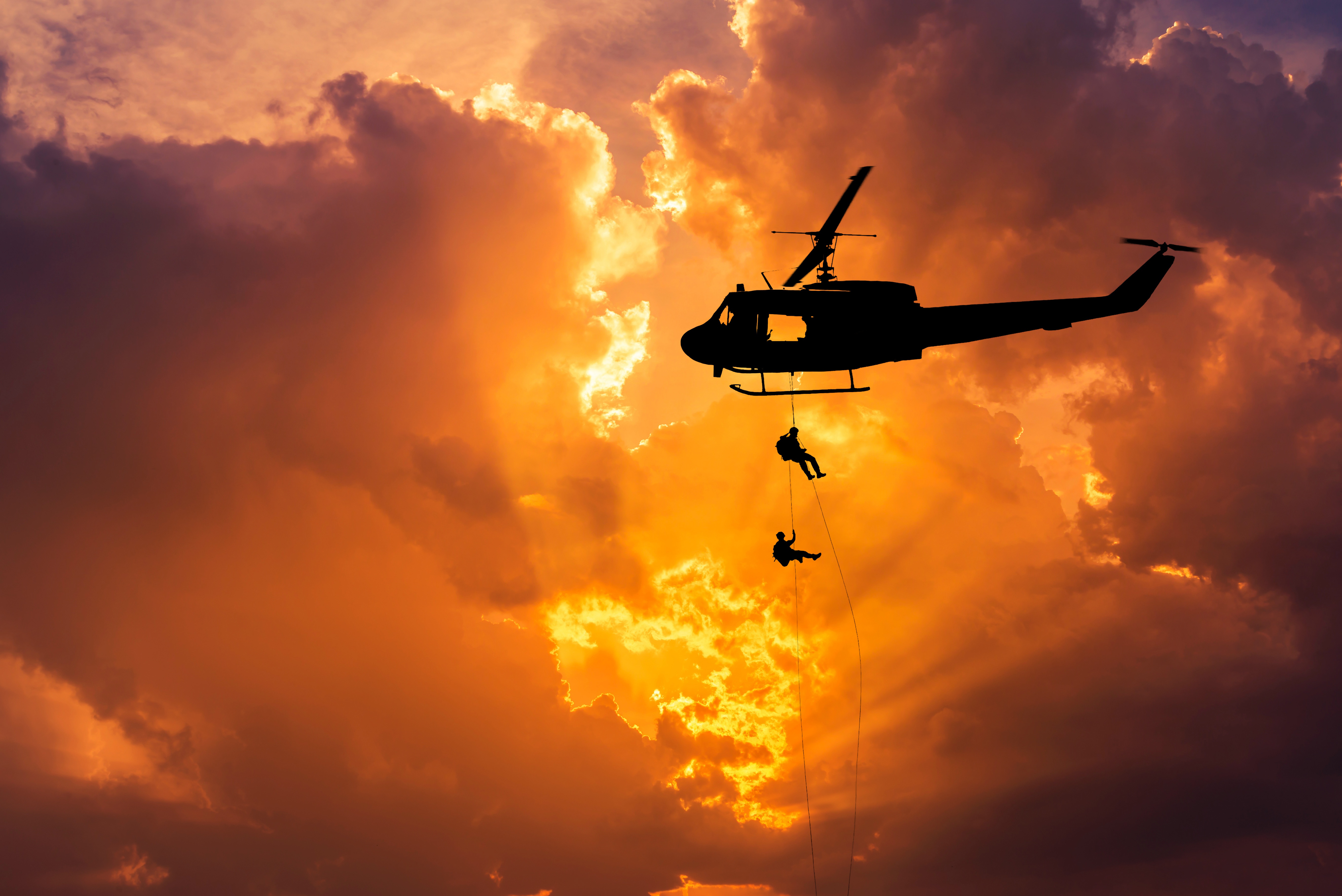 Helicopter rappelling soldiers at sunset HD Wallpaper