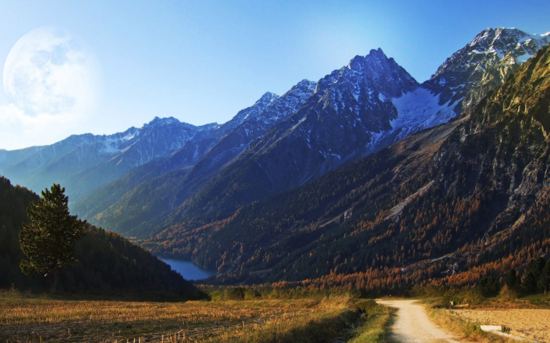 Mountain range with a lake and a dirt road HD Wallpaper