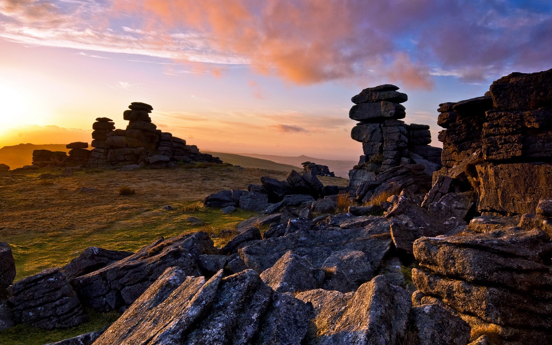 Rocky landscape at sunset with dramatic clouds HD Wallpaper