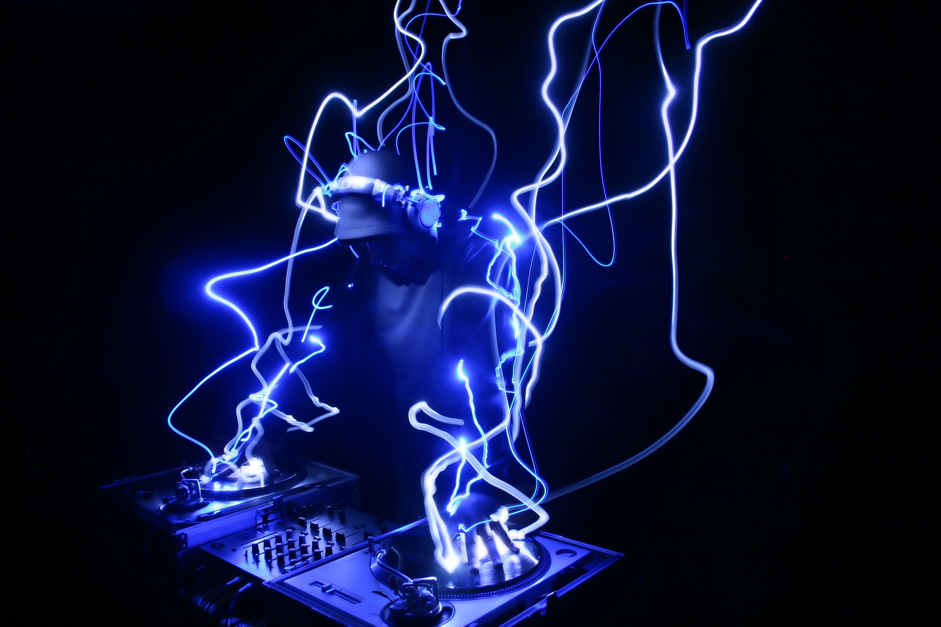 DJ performing with blue light trails HD Wallpaper