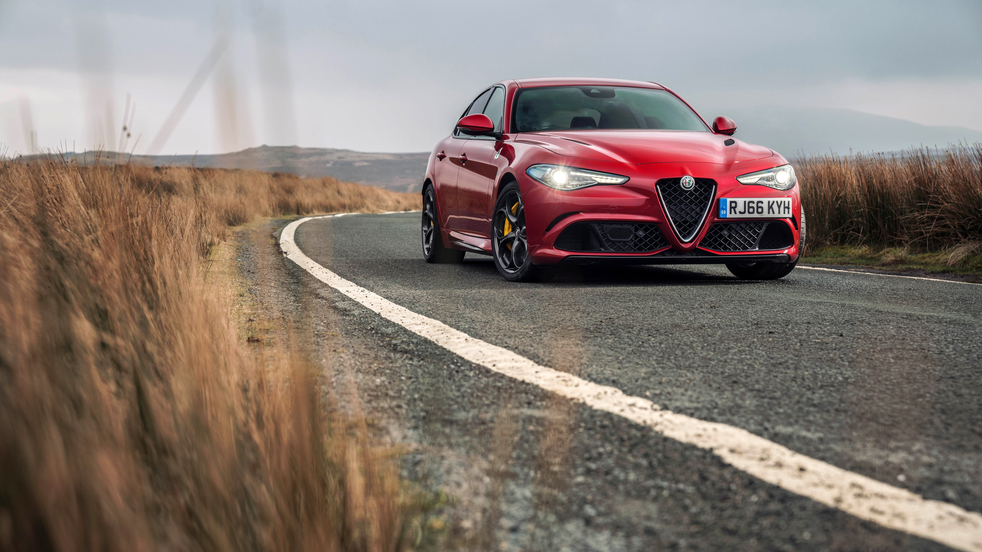 Red Alfa Romeo Giulia Quadrifoglio on a road HD Wallpaper
