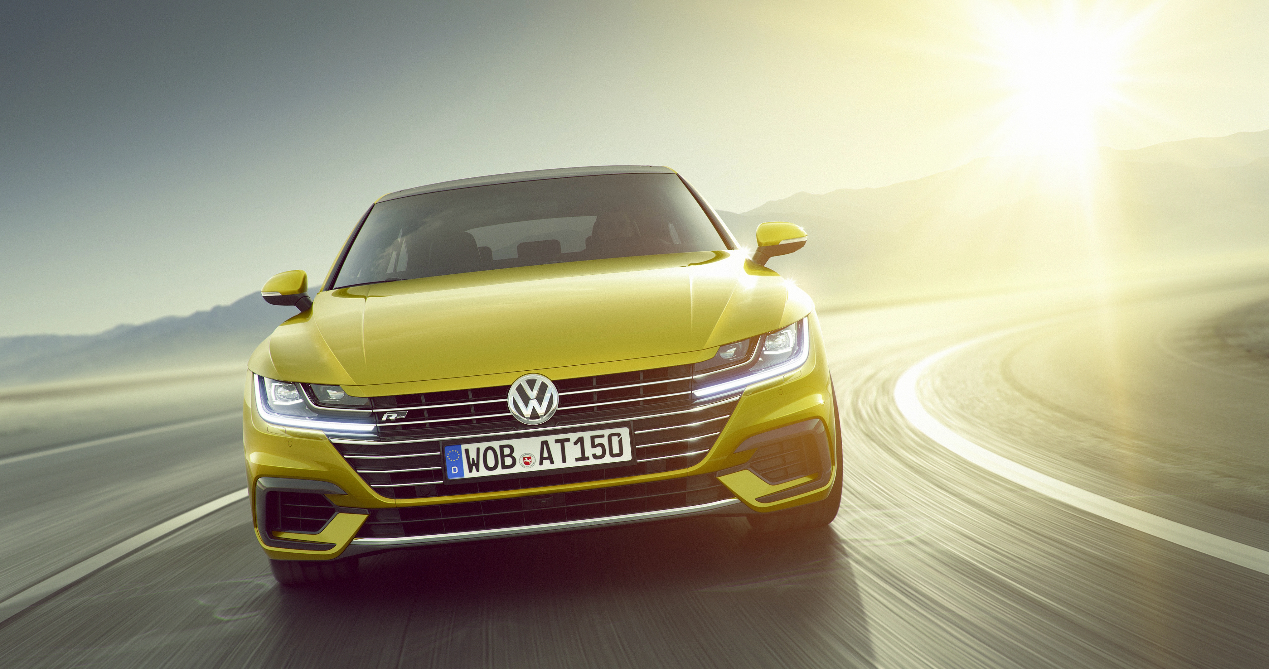 Yellow Volkswagen Arteon R-Line driving on a road HD Wallpaper