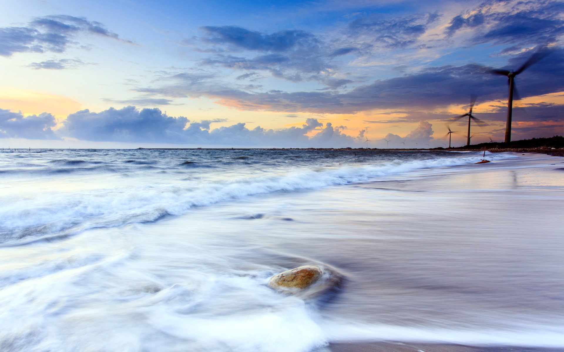 Wind turbines on a beach at sunset HD Wallpaper