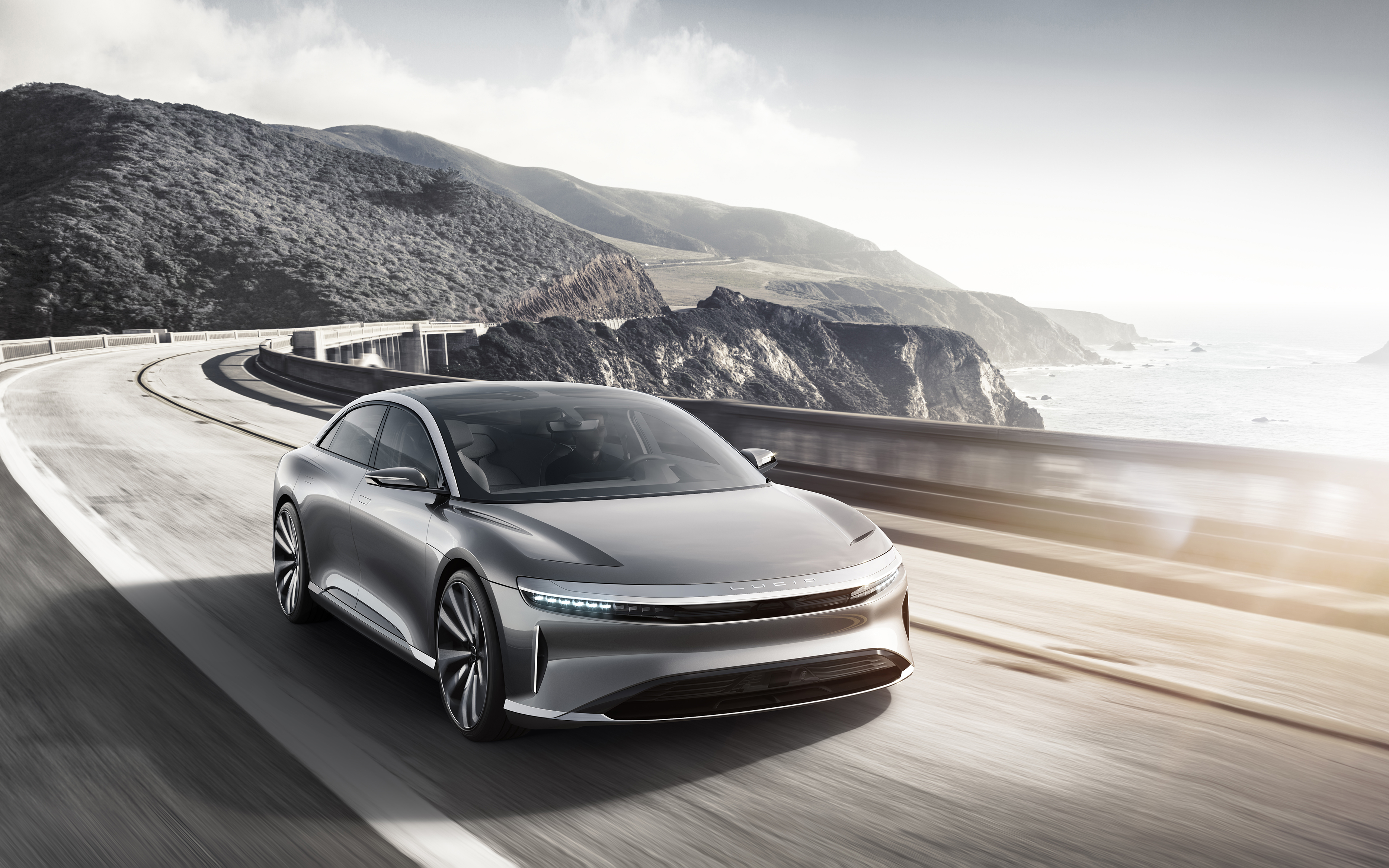 Lucid Air electric car on a coastal road HD Wallpaper