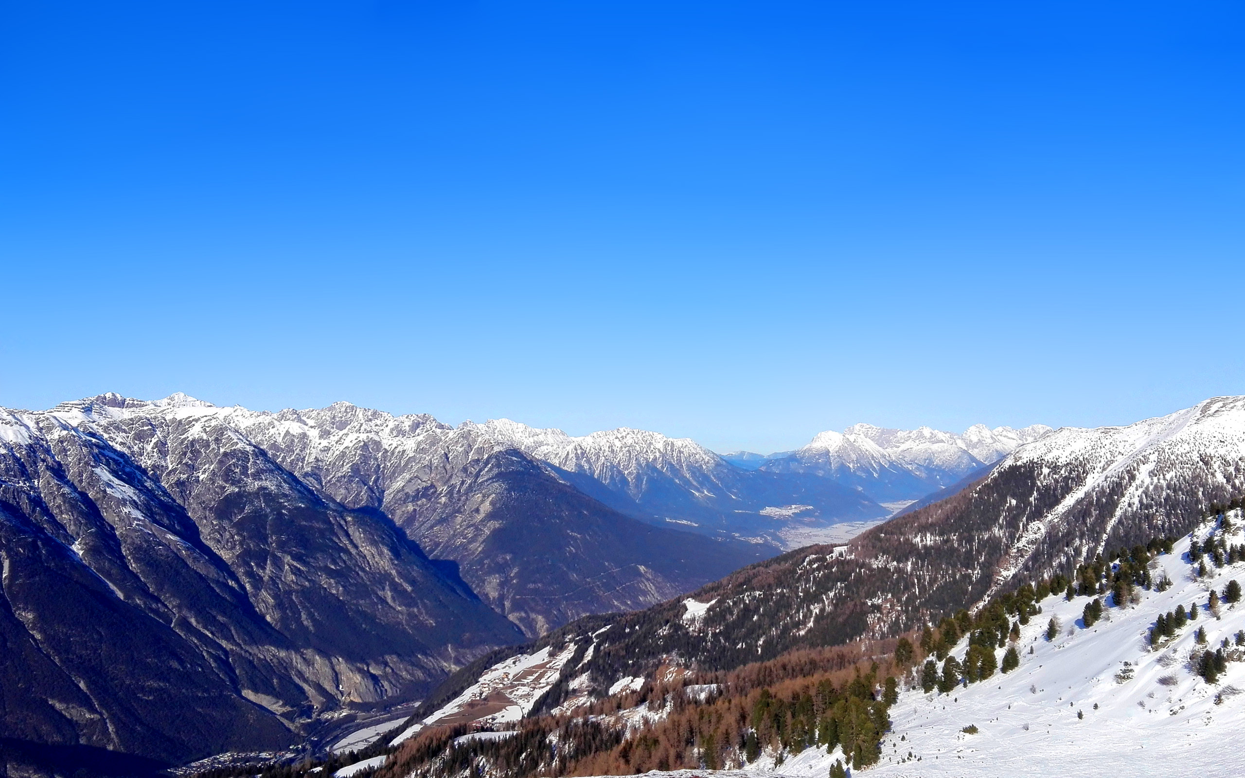 Snow-capped mountains under a clear blue sky HD Wallpaper