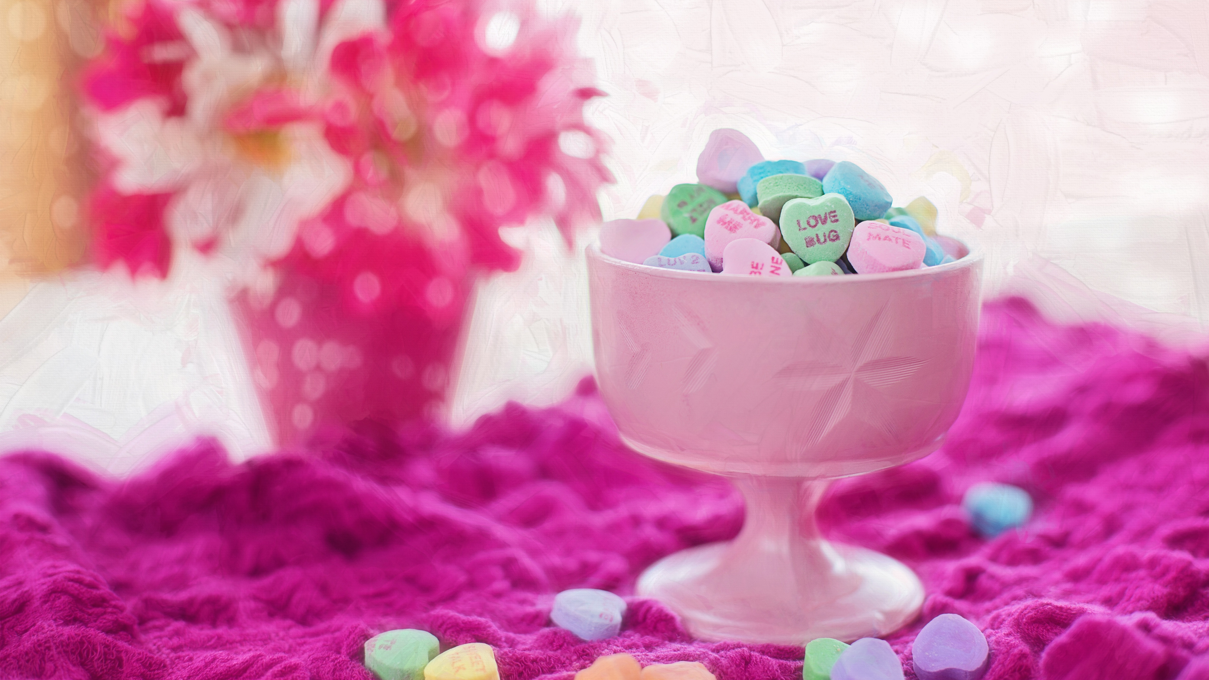Heart-shaped candies in a pink bowl with flowers HD Wallpaper