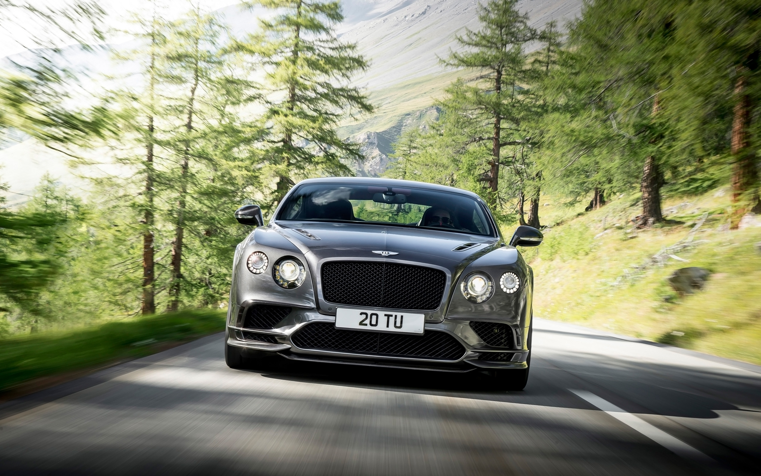 Bentley Continental Supersports driving on a mountain road HD Wallpaper