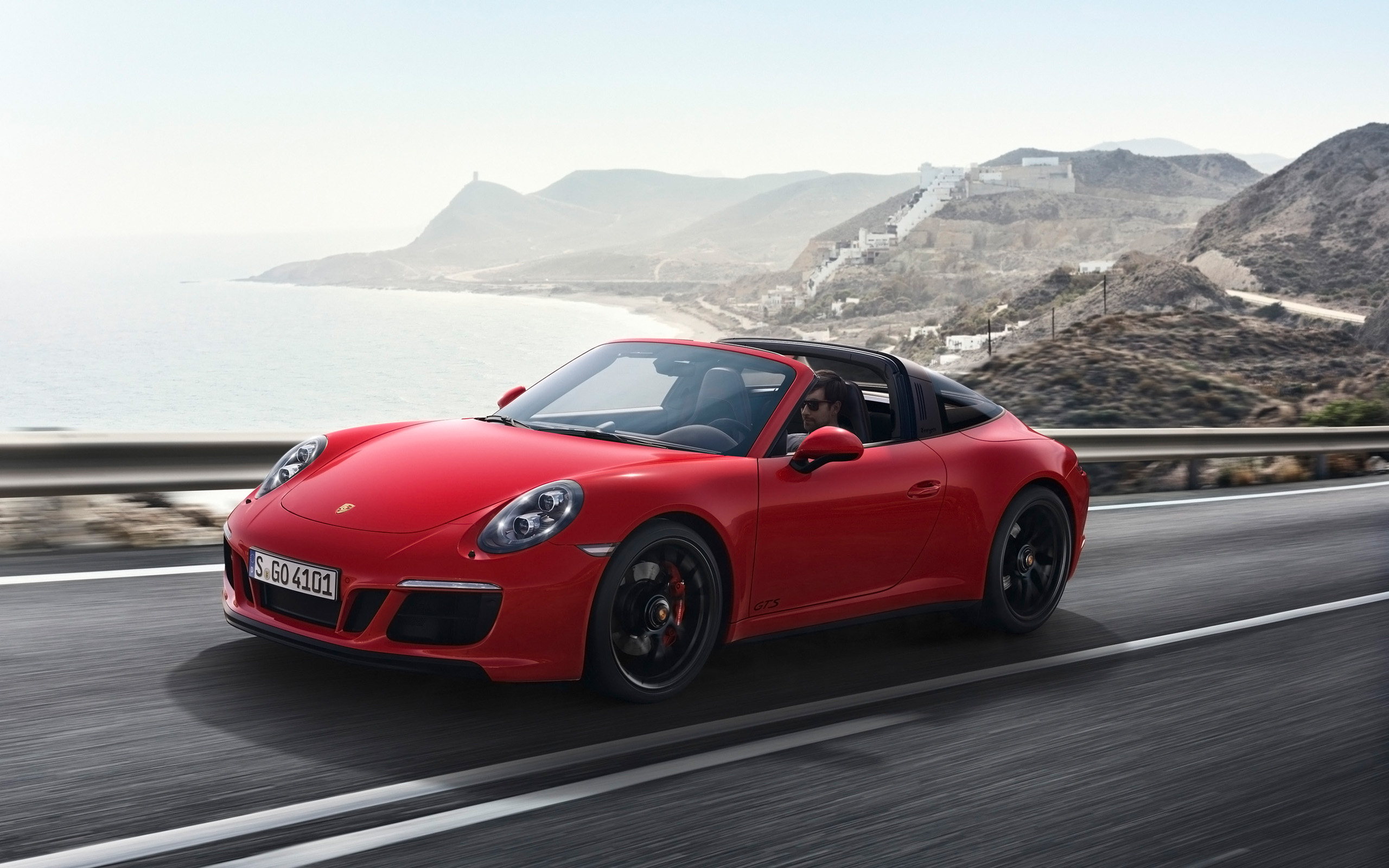 Red 2017 Porsche 911 Targa 4 GTS driving on coastal road HD Wallpaper