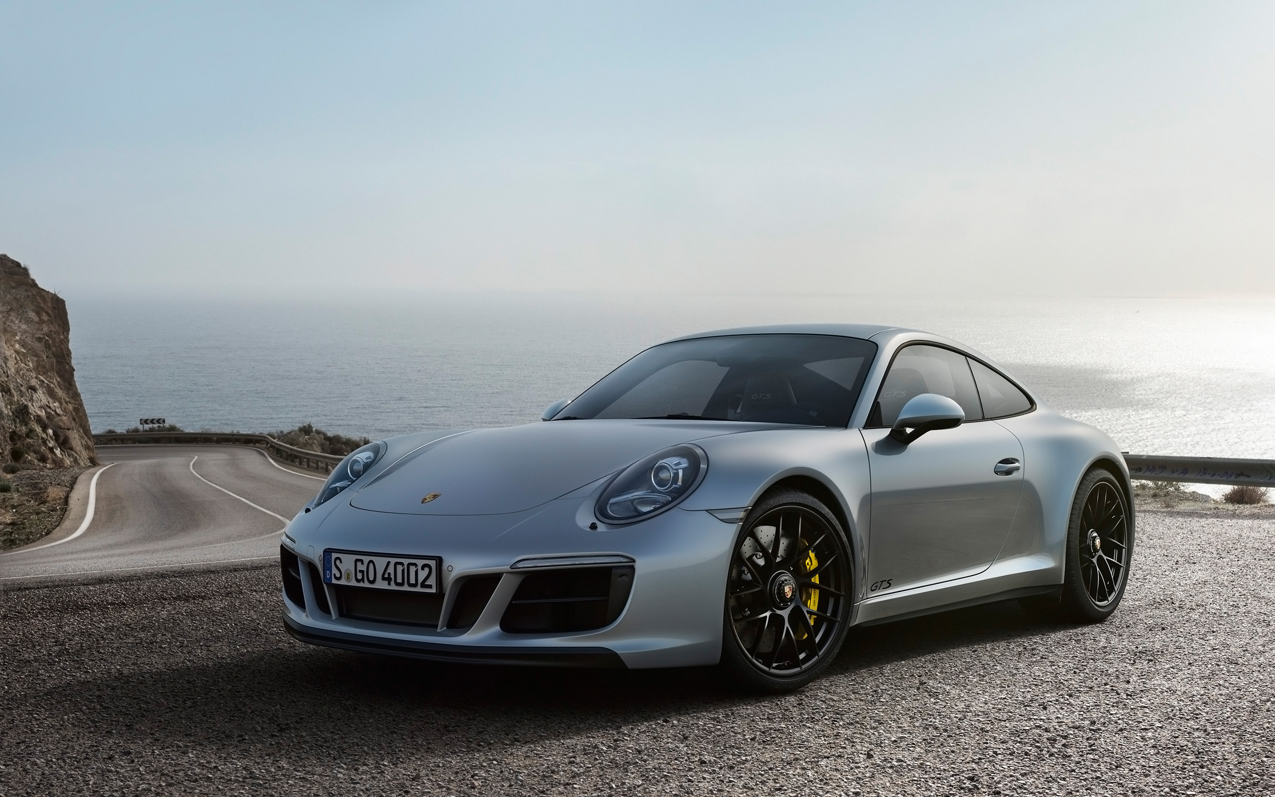 Silver Porsche 911 Carrera 4 GTS on a Coastal Road HD Wallpaper