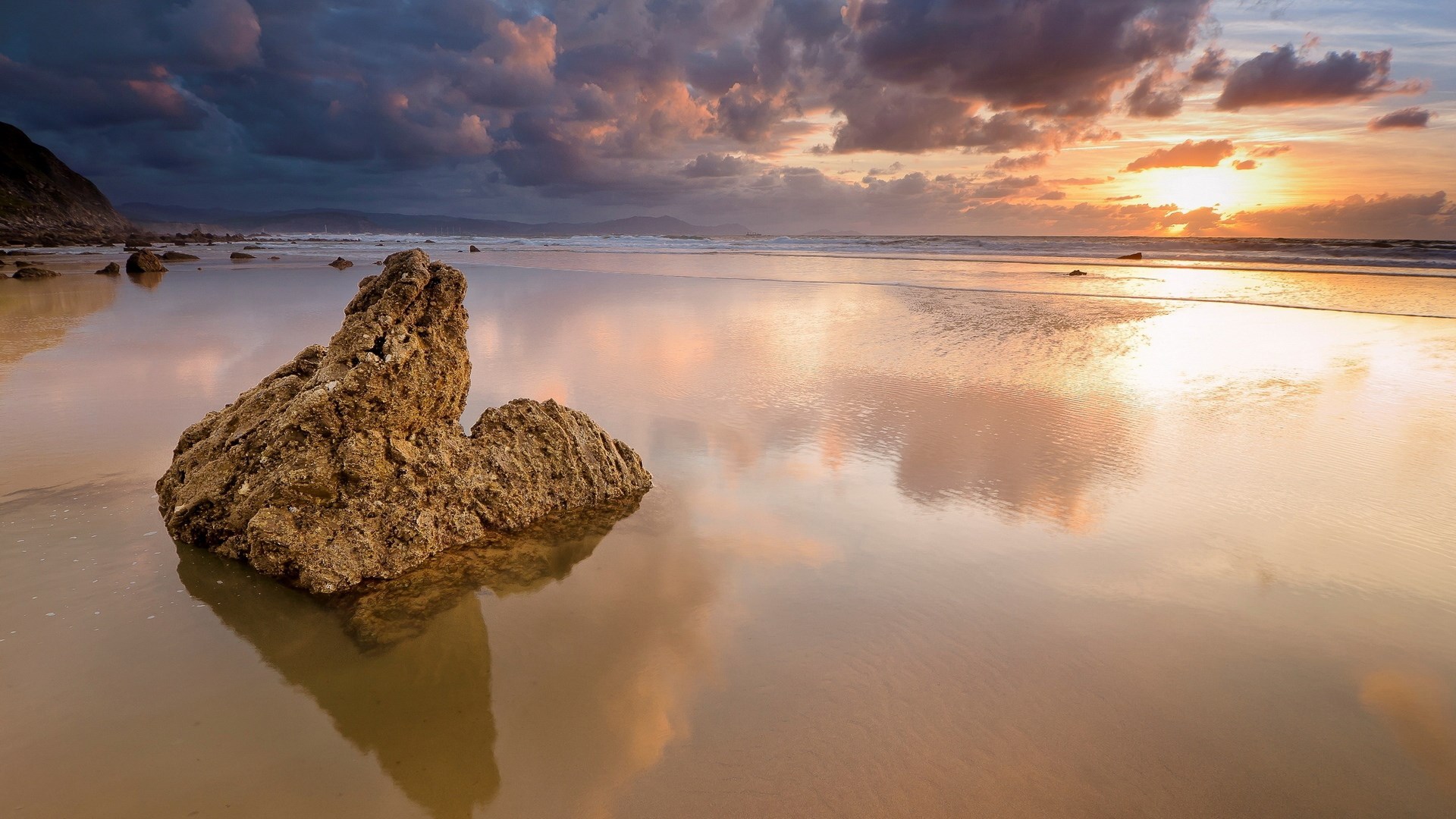 Rock on a beach at sunset HD Wallpaper