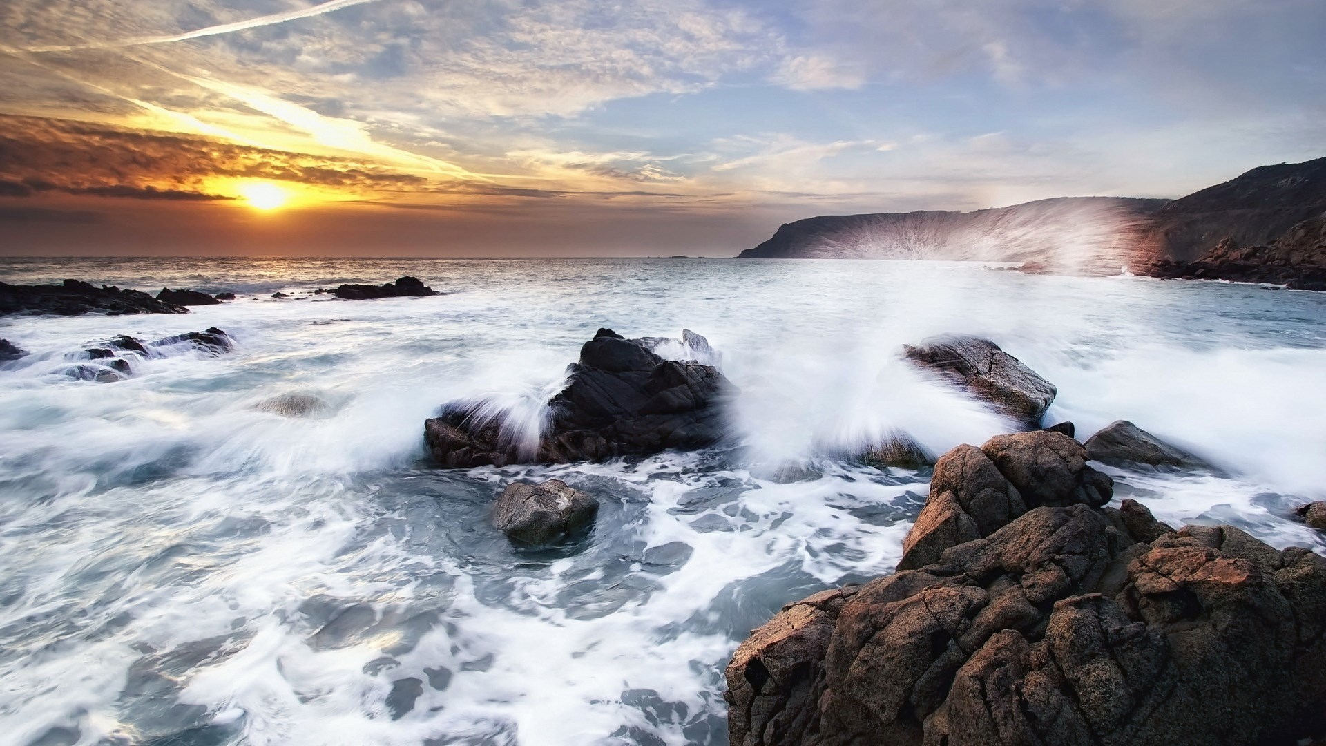 Waves crashing on rocks at sunset HD Wallpaper
