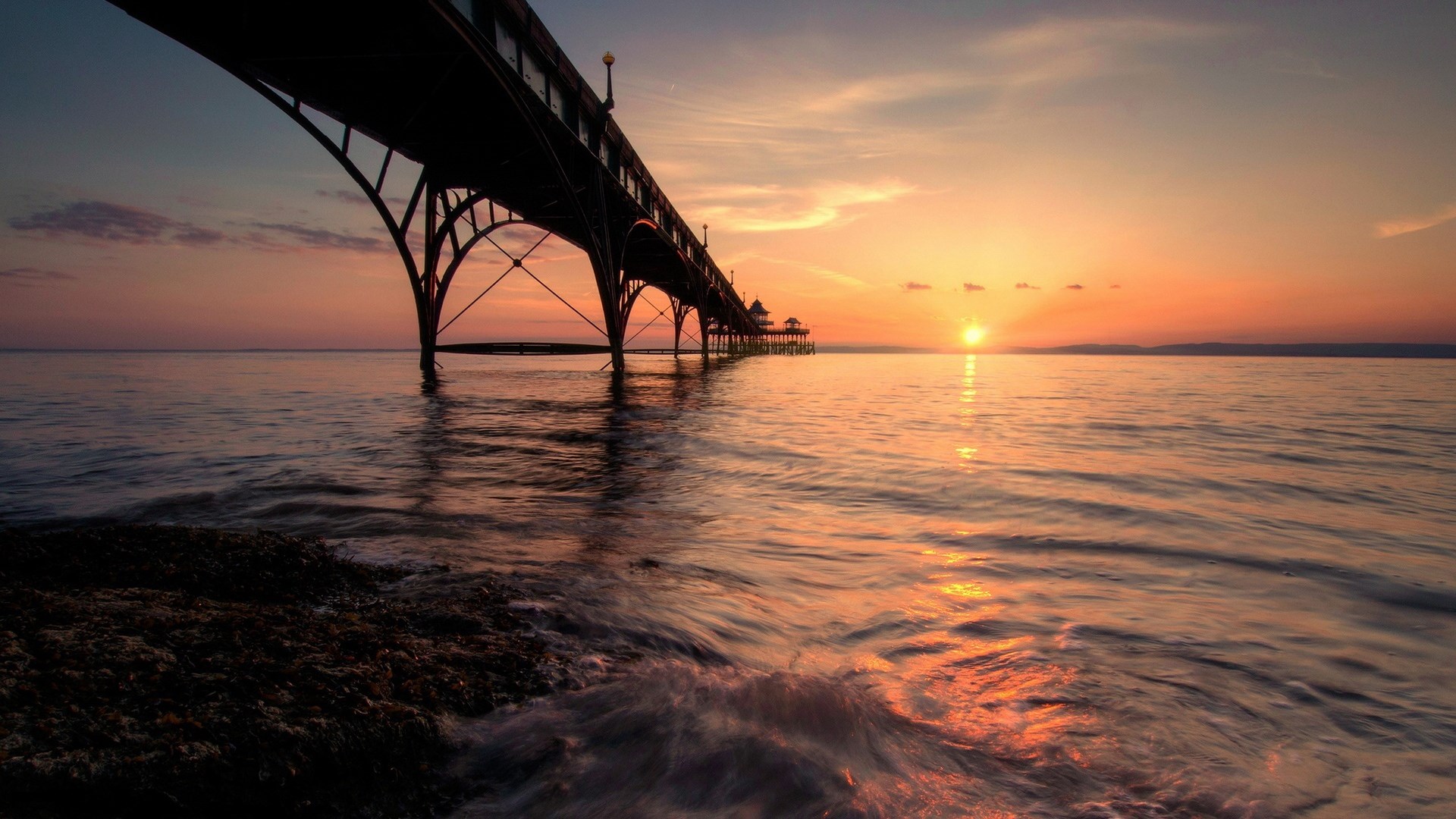Pier over the ocean at sunset HD Wallpaper