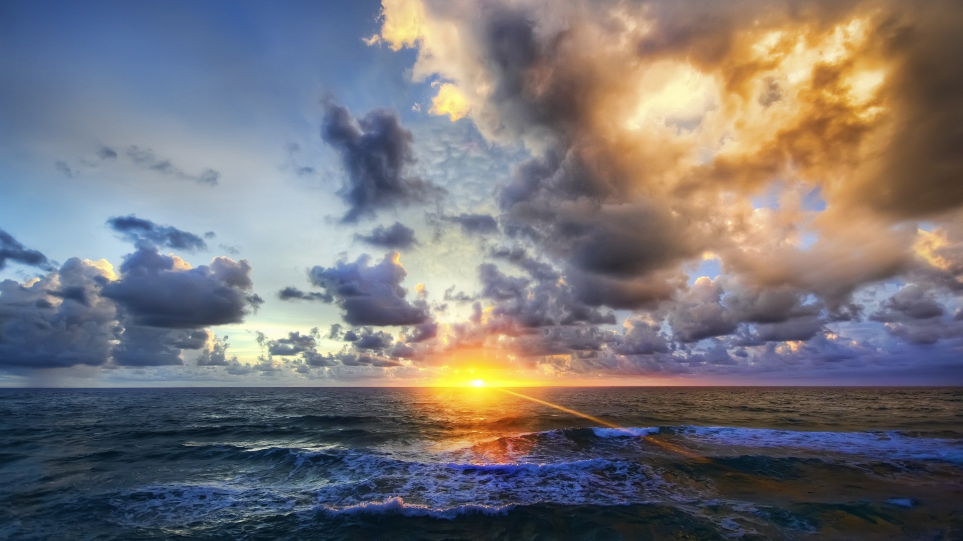 Sunset over the ocean with dramatic clouds HD Wallpaper