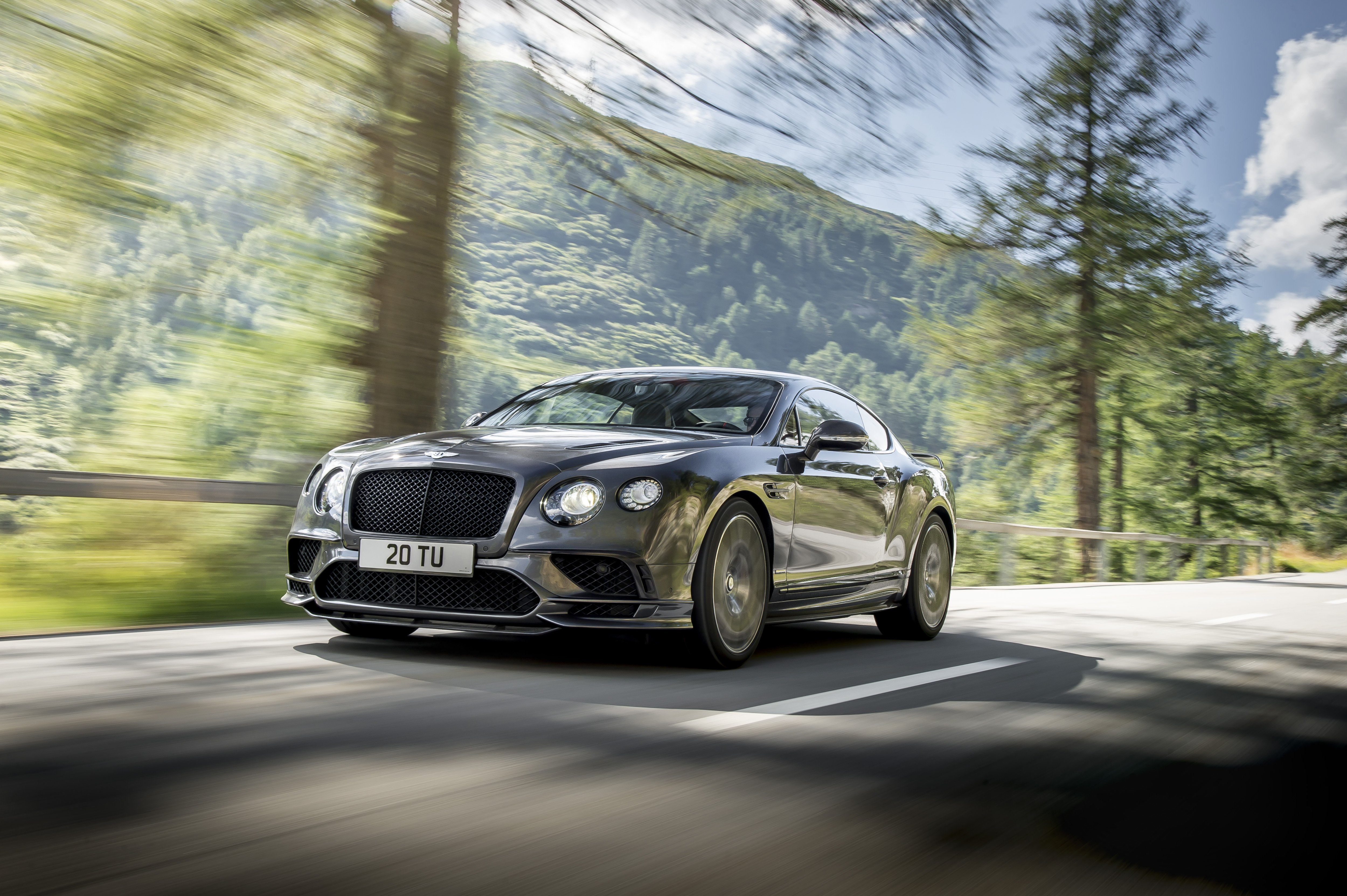 Bentley Continental GT Supersports driving on a mountain road HD Wallpaper