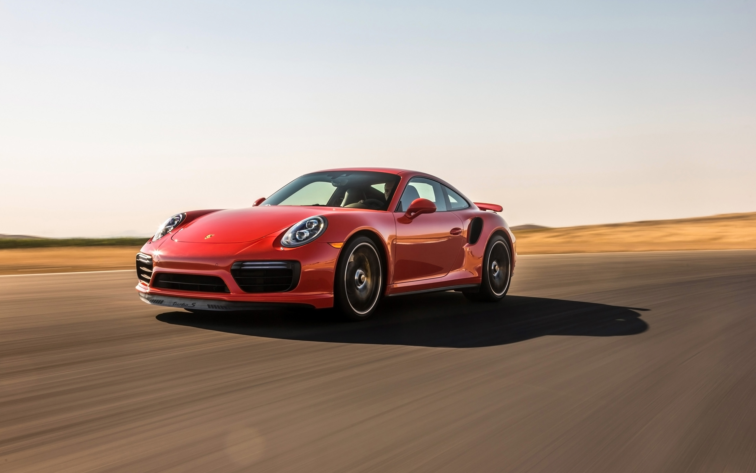 Red 2017 Porsche 911 Turbo S driving on a road HD Wallpaper
