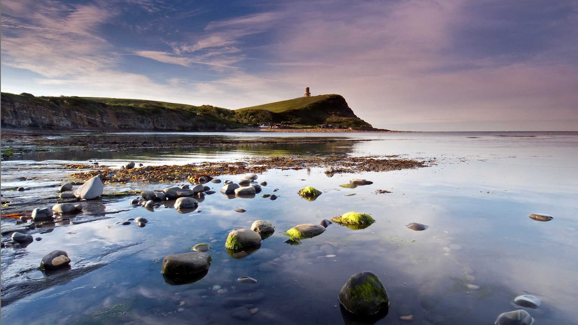 Coastal landscape with lighthouse and rocky shore HD Wallpaper