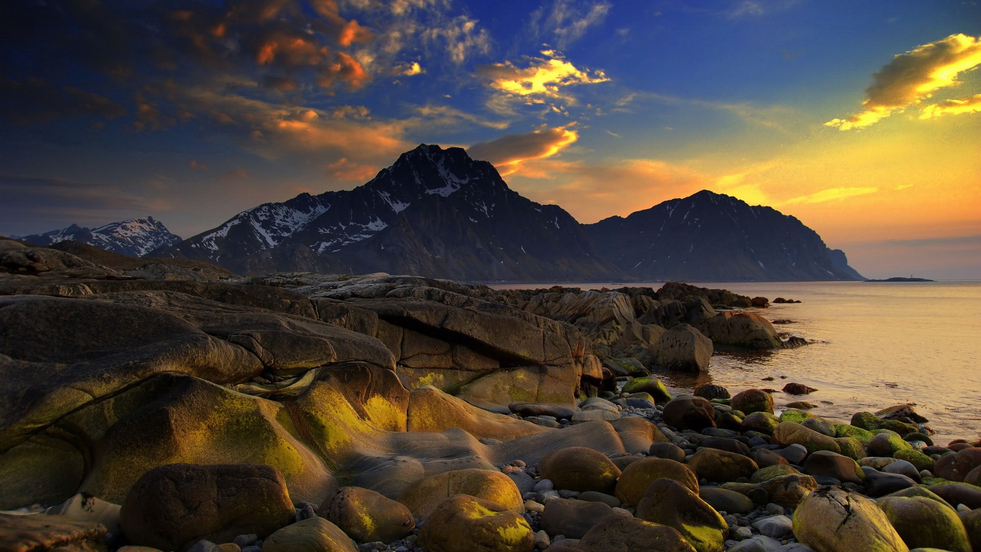 Rocky coastline with mountains and sunset sky HD Wallpaper