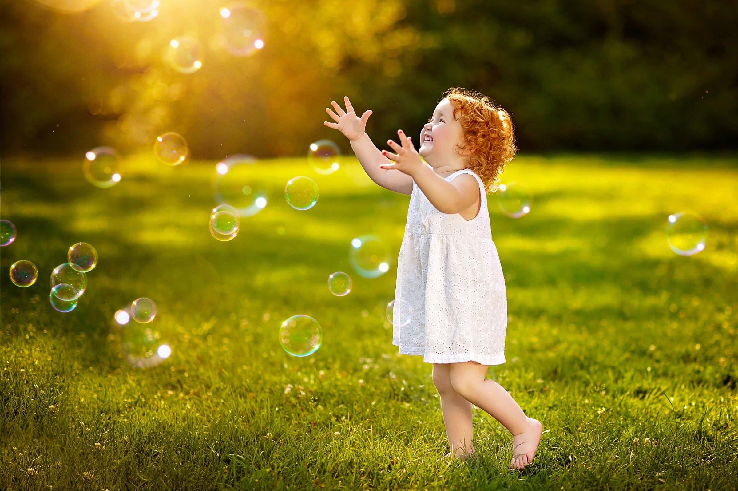 Young girl playing with bubbles in a meadow HD Wallpaper