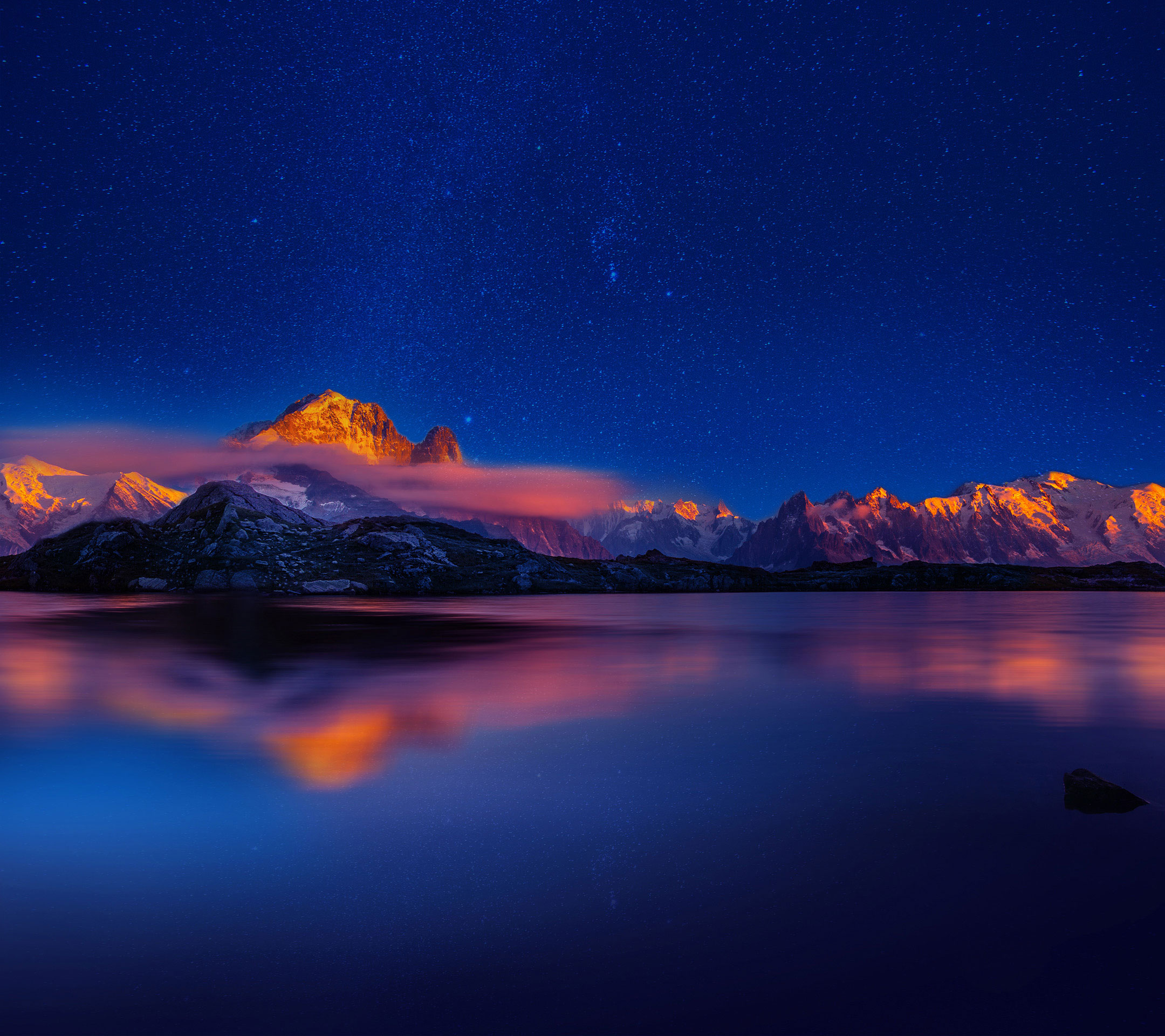 Mountains reflected in a lake under a starry sky HD Wallpaper