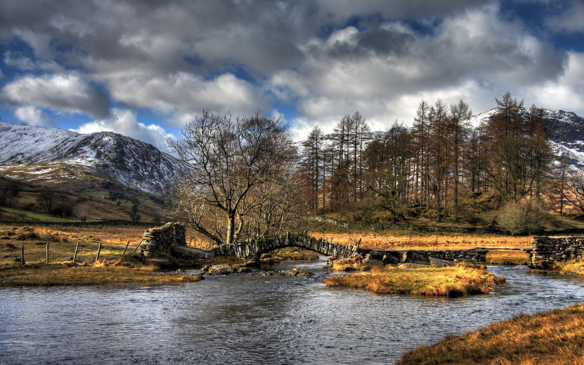 Stone bridge over a river in a mountainous landscape HD Wallpaper