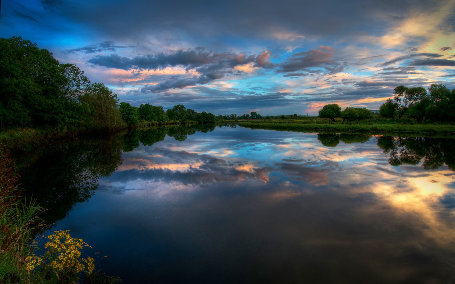 River reflecting dramatic sunset clouds and trees HD Wallpaper