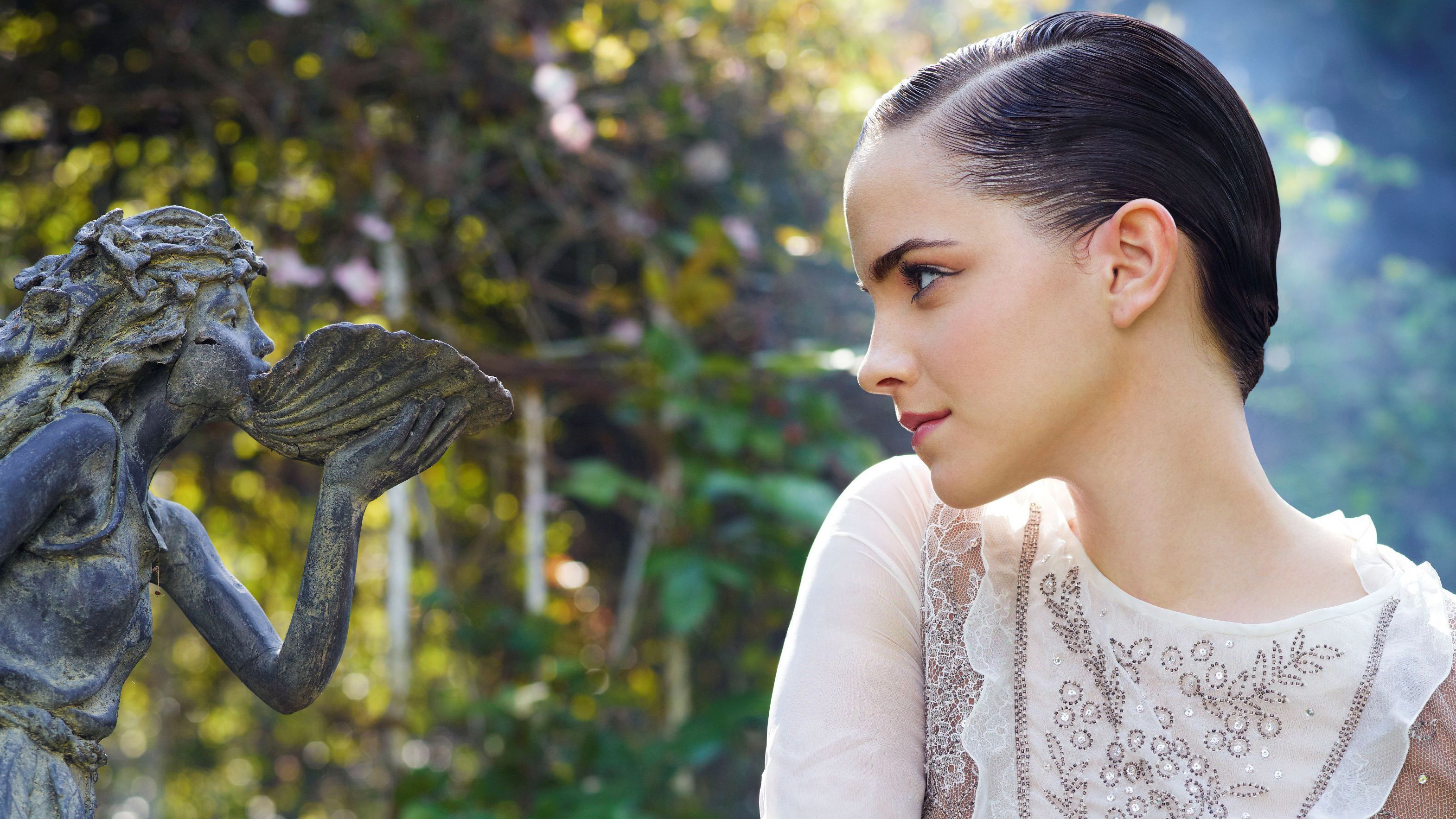 Emma Watson in a garden with a statue HD Wallpaper