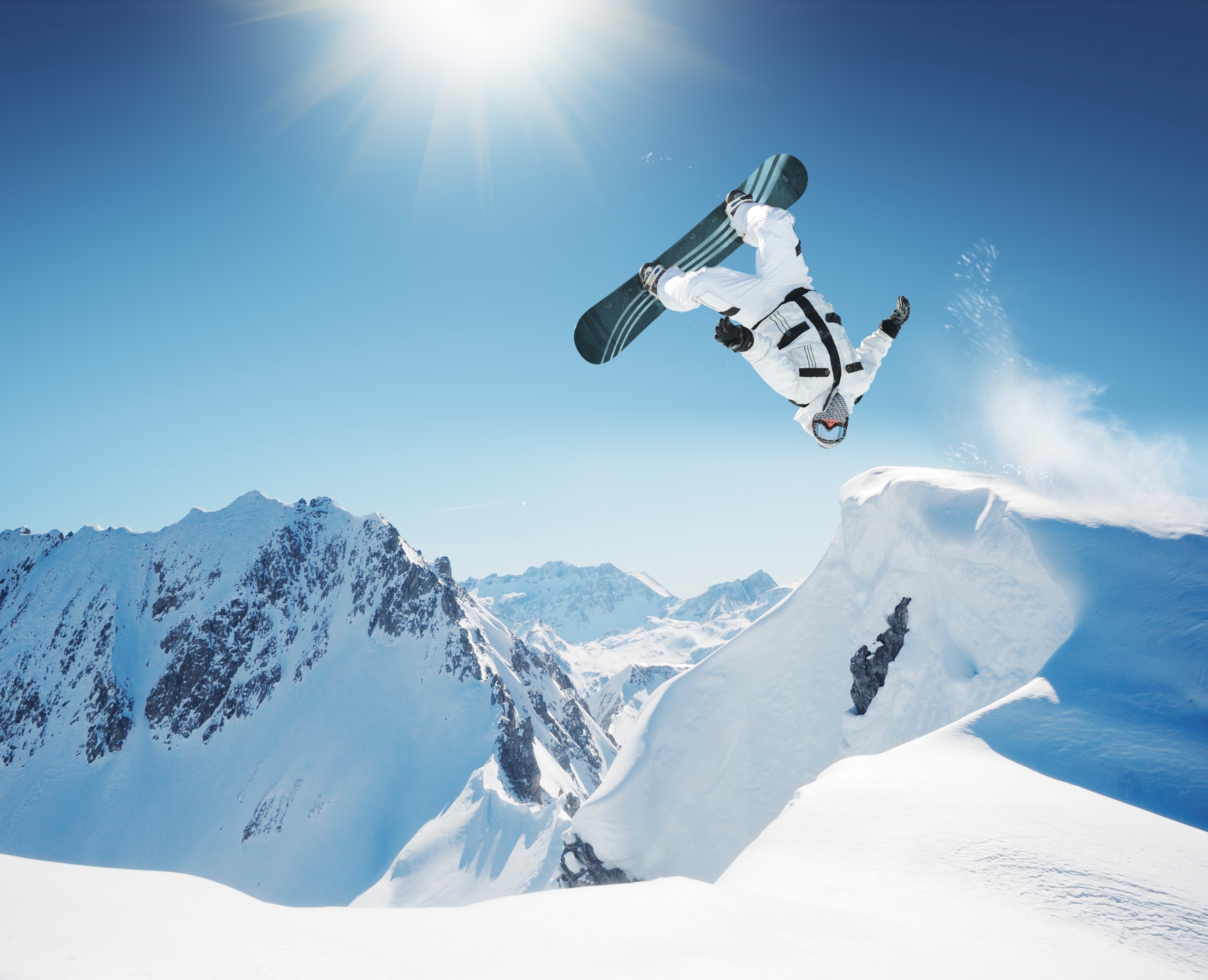 Snowboarder performing a flip in the mountains HD Wallpaper