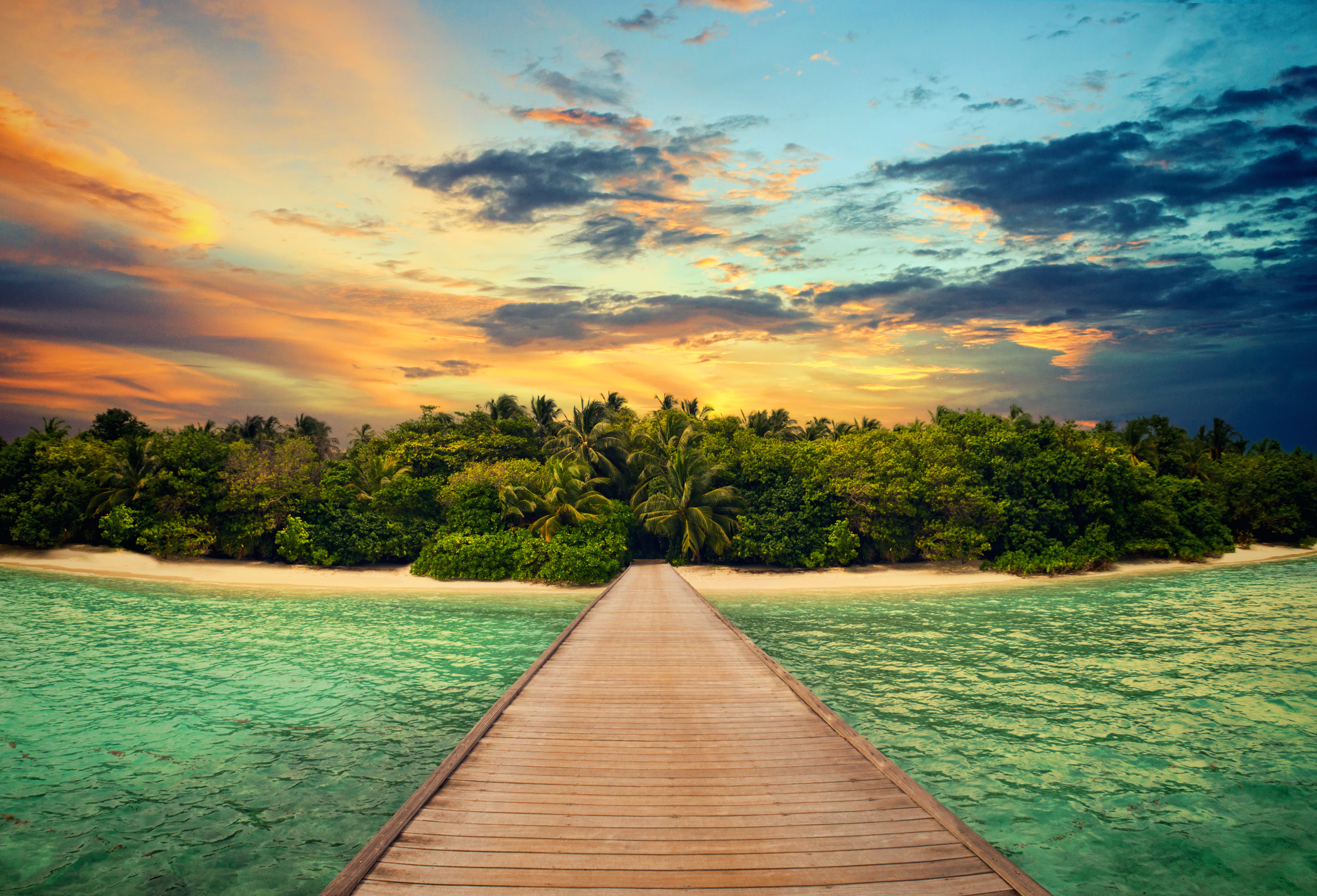 Wooden dock leading to a tropical island at sunset HD Wallpaper