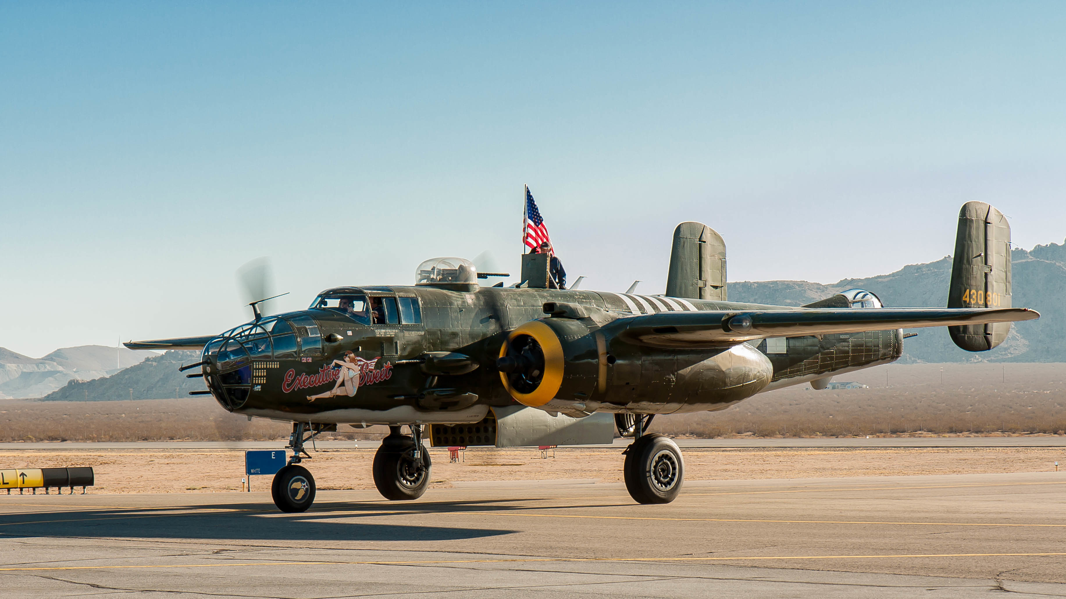 North American B-25 Mitchell bomber with American flag HD Wallpaper