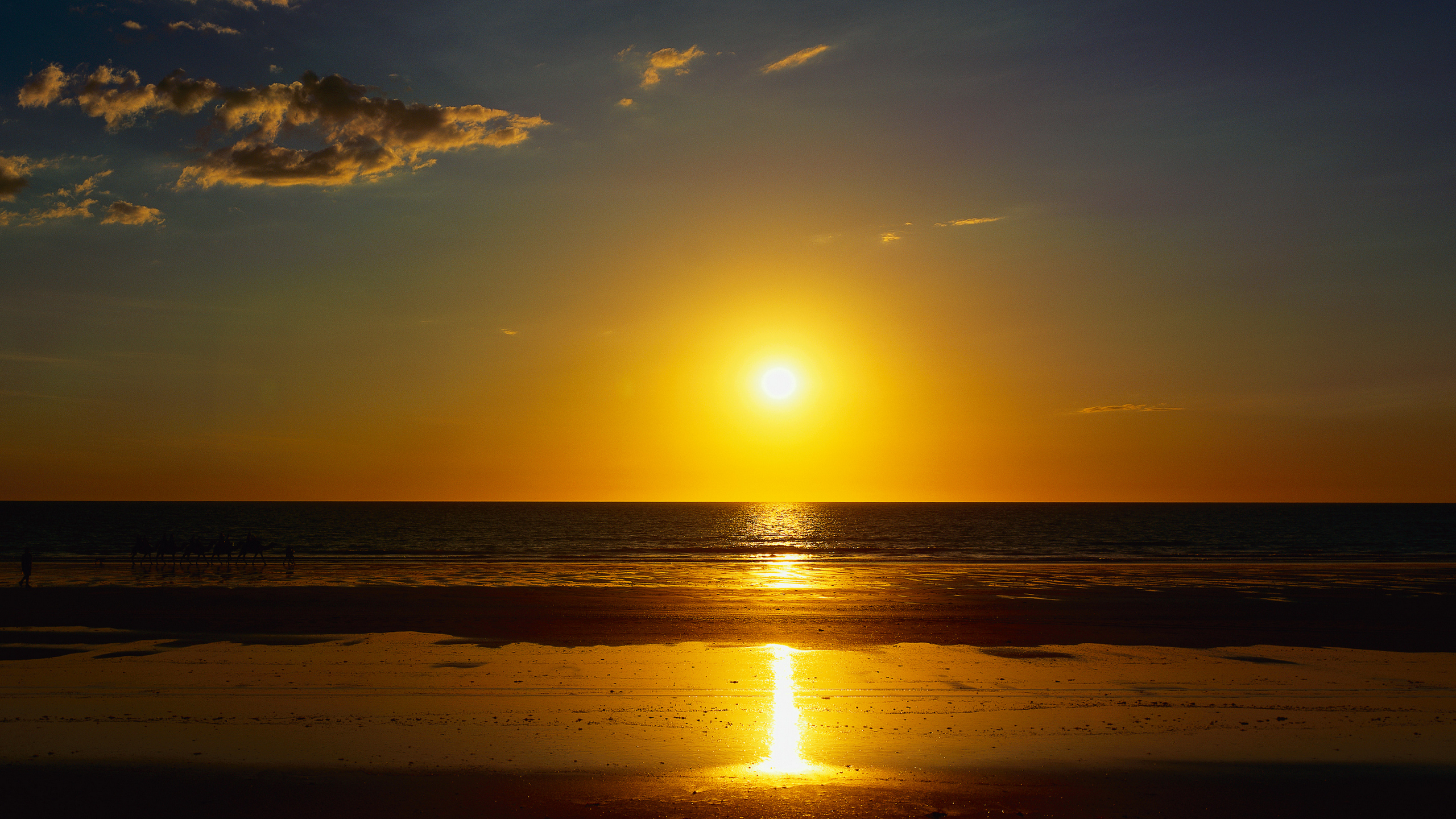 Sunset over the ocean with a beach in the foreground HD Wallpaper
