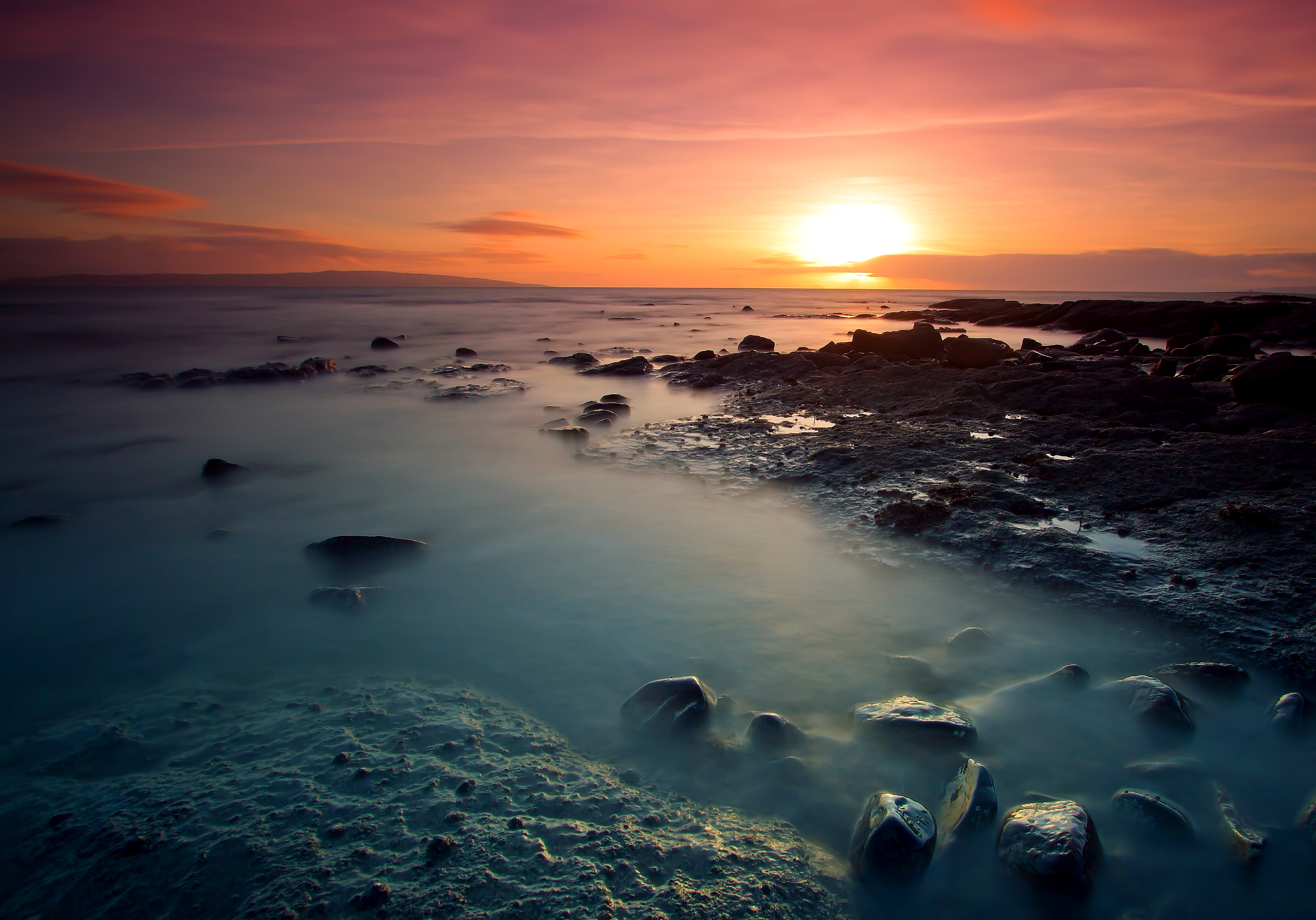 Sunset over rocky beach with ocean waves HD Wallpaper