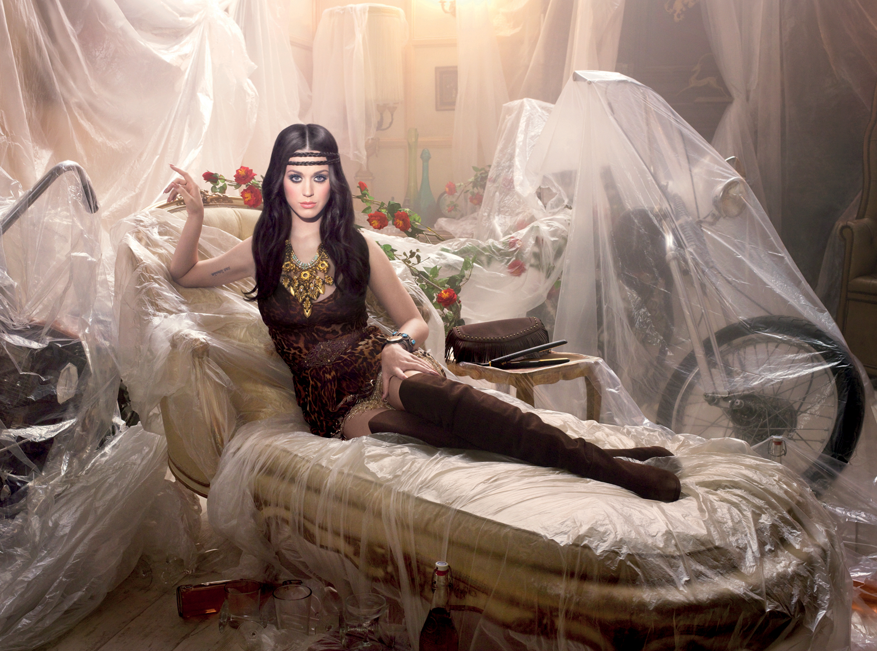 Katy Perry posing on a couch HD Wallpaper