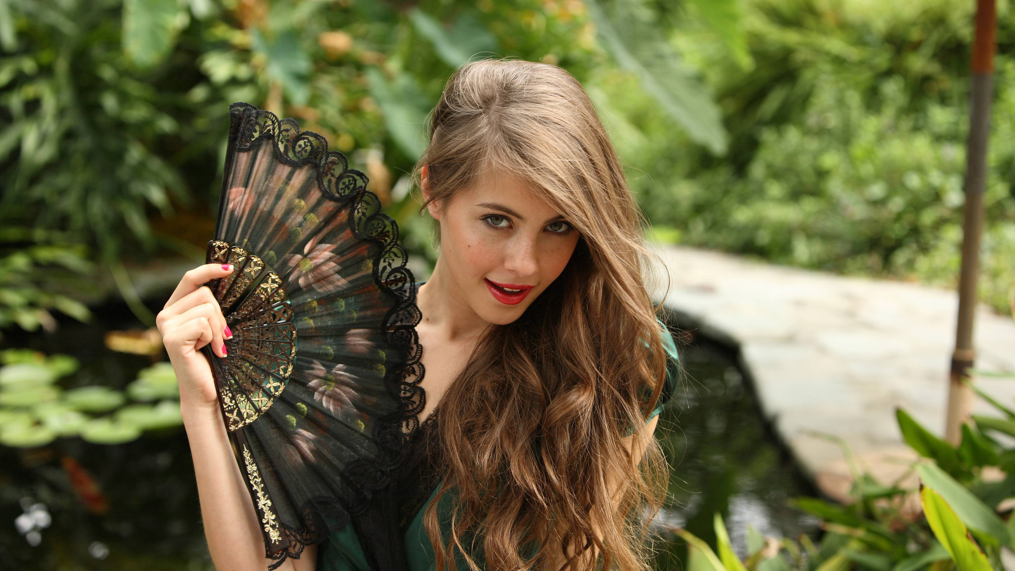 Willa Holland holding a fan HD Wallpaper