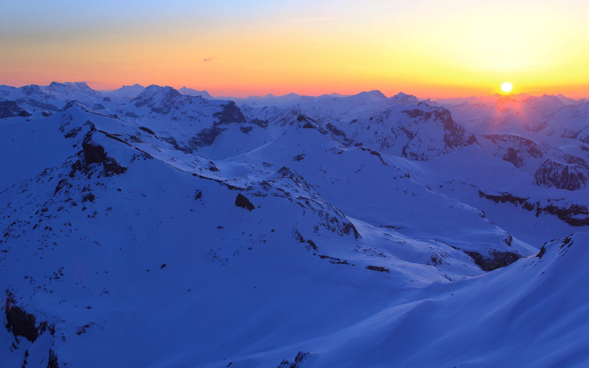 Snowy mountains at sunset HD Wallpaper